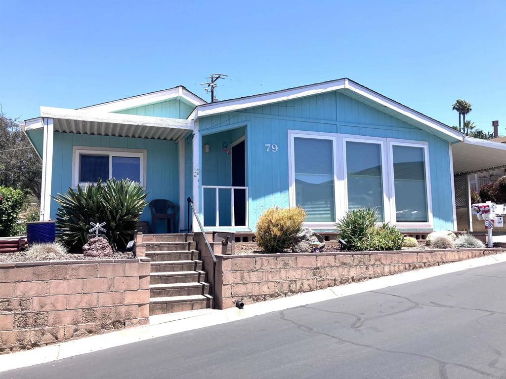 Foothills of San Marcos 55+ Land owned park. What a great place to call home. Enjoy over 1500sf of living space. Spacious remodeled kitchen with recessed lighting, beige corian countertops,and stainless steel appliances. Large living room with large picture windows to allow comforting light into the home. Good sized primary bedroom with a walk-in closet and recently remodeled ensuite bath. Newer bath includes newer double sink vanity, soaking tub, walk-in shower, newer toilet & newer flooring. Both baths have skylights. Indoor laundry room complete with utility sink. Newer water heater, a.c. unit and heater. Enjoy relaxing views and breezes from the front. Comfortable covered back patio. Nice backyard with artificial turf. So many ammenities in this active park. Community clubhouse, tennis, swimming pool, card rooms, dog park and so much more.