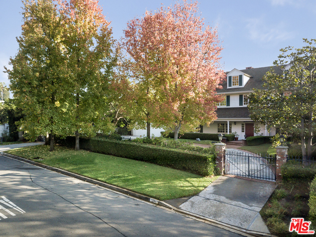Rare offering of East Coast elegance on a street-to-street lot in prime Brentwood Park. Lovely as-is or take advantage of the "good bones", including ceiling heights, sqft, and layout, to remodel into your dream home in this spectacular location. Updated kitchen cradled by a dining room, sunroom & living room with high ceilings and grand fireplace. A library and wood-paneled study on the first floor cozy up to a rich, movie-set-like foyer with spiral staircase at the estate's entrance.  Two bedrooms on the 1st floor, plus five additional bedrooms upstairs including master with walk-in closet & large bathroom. There is a wine cellar/basement that could be converted into a state-of-the-art recording studio, plus upstairs attic has been converted into bonus space. Gated front yard with motor court, private backyard with pool/spa, entertainment decks and large grassy yard.