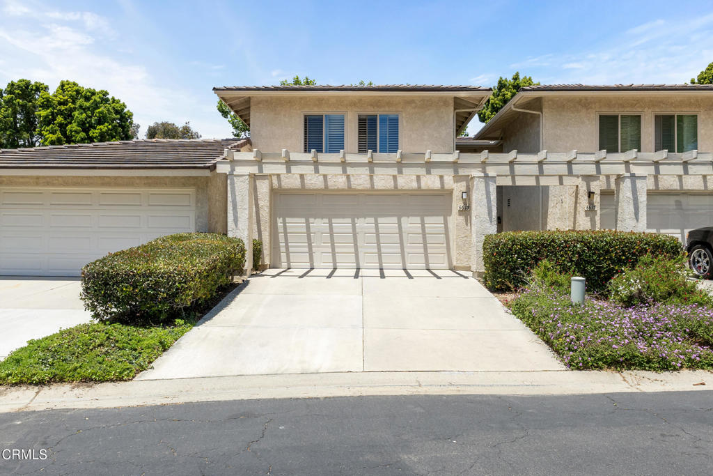 Welcome to your charming move-in-ready retreat! This delightful home blends comfort, style, and indoor-outdoor living--perfect for today's active lifestyle. Step through a private, beautifully landscaped walkway past fresh potted succulents and into a welcoming courtyard entry, complete with a sitting bench to enjoy your morning coffee, bird-watching, or a peaceful moment surrounded by greenery.Inside, the open-concept main level boasts a spacious living room with soaring ceilings, a brick fireplace, and an abundance of natural light. Relax on the inviting sectional and take in garden views through the sliding glass doors. Gather family and friends in the light-filled dining area to create memorable meals. The adjacent kitchen is bright, functional, and designed for easy entertaining, boasting generous counter space, black stainless appliances, and a deep farmhouse sink overlooking your lush entry garden.A broad stairway leads upstairs to three comfortable bedrooms, all with large windows and plantation shutters for privacy and natural light. The spacious primary suite offers tranquil views and a well-appointed en-suite bathroom with a walk-in shower. Two additional bedrooms are perfect for a home office, guest quarters, or creative studio.Step out to your private back patio -- a true oasis! Enjoy the shade of mature trees, host weekend BBQs at the patio bar under an oversized umbrella, or unwind in Adirondack chairs surrounded by manicured hedges and vibrant planters. Outdoor living is effortless here, with ample space to dine, entertain, and relax.Other highlights include a stylish guest bathroom, central heating, and ample storage space in the two-car garage. Enjoy the unique blend of contemporary convenience and cozy charm in this beautifully maintained home.Don't miss your chance to own this inviting home--schedule your tour today!