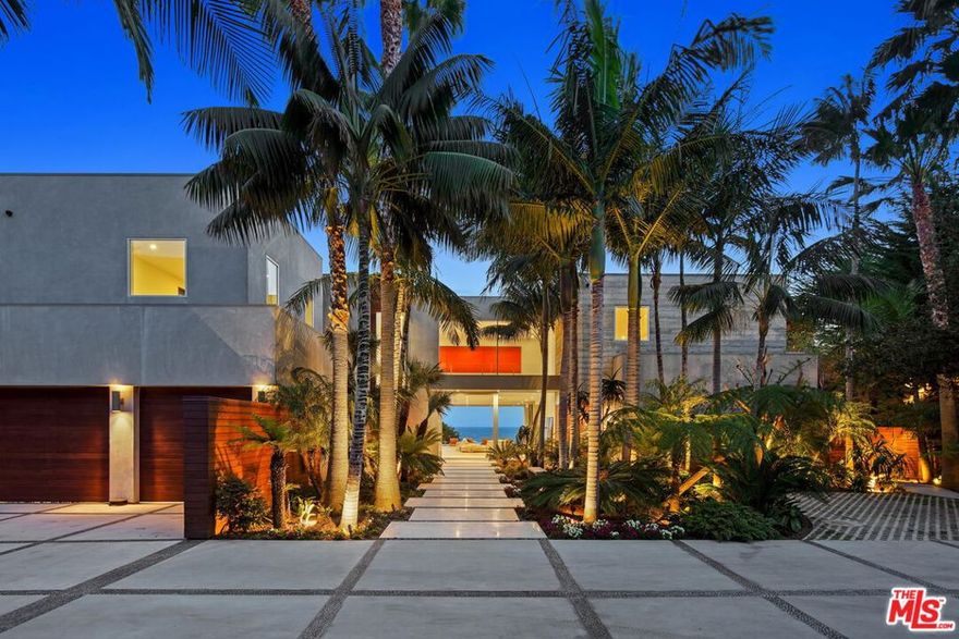 A rare modern estate with 7-bedrooms, 11 bathrooms and  approximately 10,348 square feet of exceptionally tasteful living space.  The entrance initially welcomes you in with lush tropical forestry and beautifully hardscaped walkways, leading you to the remarkable glass pivot front door which seamlessly blends the entrance with the homes foyer.  Upon entering, the 67' foot infinity pool and uninhibited ocean view of County Line beach solidifies this home as an exceptional example of California designed indoor/ outdoor living. The expansive living, dining, kitchen and bar comprehensively open the home to the exterior, optionally the doors and windows can be tucked away for a uninterrupted aesthetic. Additionally the property is complete with a sunken bar, home theatre, showcase column wine fridges, billiards room, multiple poolside covered bungalows, outdoor media and kitchen, saltwater coral aquarium, elevator, roof top putting green, laundry room with a dog washing station and three washer and dryer units, an extensive gym with service entrance for trainers and masseuses', a fully equipped chefs kitchen with separate service entry and a removed guest house with a two car garage, and full kitchen. Effortlessly entertaining and hosting guests is one of many advantages of this property, and while guests can enjoy the properties amenities, the primary suite can be closed off from the rest of the home in complete privacy.  The primary bedroom resides on the second level, and expands across the entirety of the south/west side of the home, with three decks, two bathrooms, two walk-in closets, an office, wet bar, panic room and secondary, hidden entrance to the gym.  Privacy is of the upmost significance, as the property is thoroughly fenced and gated, and while you feel as though you're right above the ocean, anything in your surroundings is completely out of sight, offering the buyer a great sense of security. While there are very few reasons to leave this quintessential Malibu property, a private airport is only a 25 minute drive up the coast.