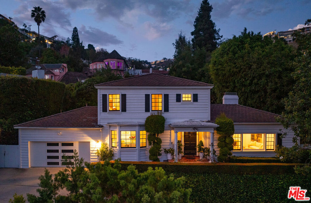 GORGEOUS TRADITIONAL IN PRIME SUNSET PLAZA. Tucked away at the end of a quiet cul-de-sac, this timeless traditional estate blends classic sophistication with modern refinement. A private driveway leads to a sun-drenched residence surrounded by lush greenery and complete privacy just moments from the heart of the Sunset Strip. Inside, a sweeping staircase introduces the home's graceful interiors. The expansive living room captures picturesque city views and flows seamlessly into the formal dining room. A bright sun-room offers the perfect setting for both intimate gatherings and large-scale entertaining. At the heart of the home, a sleek custom Minotti kitchen impresses with concealed appliances, bespoke cabinetry, and abundant storage delivering a clean, contemporary aesthetic. The main level features two bedrooms, while the upper floor hosts two spacious ensuite bedrooms, including a luxurious primary suite with dual walk-in closets and city vistas. Outdoors, discover a private entertainer's paradise - expansive terraces, a resort-style pool with multiple lounging areas, and a chic cabana enveloped by mature landscaping. Perfect for serene relaxation or glamorous entertaining under the stars. A rare offering of elegance, privacy, and comfort in one of Los Angeles' most coveted enclaves, just minutes from world-class dining, shopping, and nightlife on the iconic Sunset Strip.