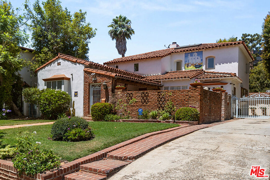 This original 1930's Spanish home is in prime Little Holmby, set on a picturesque, tree- lined, street! 4 bedrooms, 6 baths and 3,275 square feet of living space- full of authentic charm, including hand painted mosaic tile murals throughout! Original details include exposed beam ceilings, vintage tiles, hardwood floors, French doors, crown moldings and coffered ceilings- a little TLC and updating will unlock this charmer's full potential. Enter through a private, enclosed, courtyard and enjoy the great indoor/outdoor flow via French doors to both the living room with beamed ceilings & fireplace and spacious dining room with Dentil molding. The kitchen has been updated with stainless steel appliances and granite countertops. Downstairs includes a wood paneled office and separate den, both with bathrooms. There are also two bedrooms downstairs, the larger of which has access to a full bath with vintage tiles and leads to the outside patio. The skylight above the staircase supplies lots of natural light leading to the two upstairs en-suite bedrooms. The very spacious primary suite features a fireplace, walk-in closet, large bathroom with separate bathtub and a covered patio. The rear of the house opens to a lovely tiled patio inclusive of murals and a converted garage that is currently used as an office with bath; it could easily be converted to an ADU. Located within the highly regarded Warner Avenue elementary school districts near UCLA, Westwood Village, Holmby Park, Geffen Playhouse & Hammer museum. Bring your imagination and restore this beautiful home to its original glory!