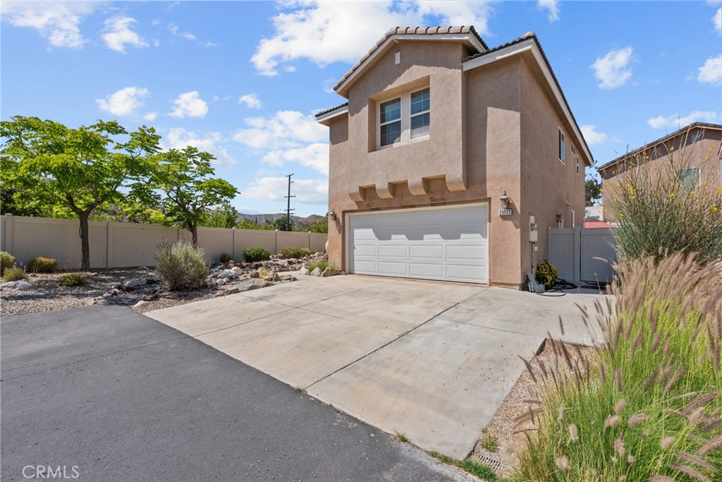 Wonderful former model home located at the end of a peaceful cul-de-sac in the desirable Mint Canyon community with one of the best locations in the neighborhood! This beautiful two-story home features 4 spacious bedrooms and 2.5 bathrooms. Inside, you'll find a light and open floor plan that is freshly painted with neutral tile flooring throughout the downstairs and carpet upstairs. The formal living room features a cozy fireplace and a built-in media center, while the adjacent dining area provides the perfect space for entertaining. The kitchen is both functional and stylish, boasting sleek granite countertops, an ample center island, breakfast bar, recessed lighting, large pantry with double doors, a double oven, built-in microwave, cooktop, and refrigerator. A charming dining nook with a stylish designer light fixture and French glass doors leads directly to the large backyard where you’ll enjoy stunning mountain views, an enchanting cobblestone patio area, built-in planters, a serene pond, BBQ area, and a private above ground spa - perfect for playing with a pup, relaxing, or hosting your friends and family. Upstairs, the loft area features a built-in office nook perfect for working from home or doing homework, and the laundry room offers added convenience. The primary suite is a true retreat with dual walk-in closets, a spa-style bathroom complete with an oversized jetted tub, dual sinks, separate shower, and a private toilet room. Additional upgrades include a surround sound system, pre-wired alarm system, ceiling fans, huge additional storage space beneath the stairway, and durable vinyl fencing. With a low HOA, no Mello-Roos, direct two-car garage access, and a prime location perfect for locals and commuters alike just minutes from the 14 Freeway, shopping, schools, parks, and the College of the Canyons, Canyon Country campus less than a mile away, this home offers both comfort and convenience in every way!