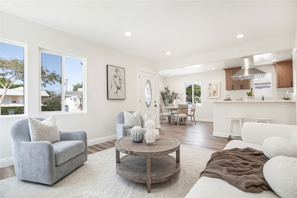 Fully renovated with all city permits, this beautiful single-family home is situated in the highly desirable and quiet residential area west of Culver City—just one mile from the center of Marina del Rey! Offering the ideal blend of modern urban living and coastal convenience, this property places you close to shopping, dining, parks, and everything this vibrant city has to offer. Inside, a bright front living room welcomes you with large dual-pane windows, recessed lighting, and laminate plank flooring that flows throughout. The open-concept dining area leads into a stunning kitchen featuring warm wood shaker cabinets, quartz countertops, and stainless steel appliances with designer hood and a brand-new dishwasher. The home offers three comfortable bedrooms, each with ample closet space and recessed lighting. Both bathrooms are tastefully updated, including one with a sleek vanity, LED-lit mirror, matte black fixtures, and a modern tub-shower combo with marble-style tile. A spacious, separate family room at the rear of the home showcases a wood-beamed ceiling, brick fireplace, and sliding glass doors on both sides—one opening to the detached 2-car garage, the other to a private backyard patio—making it perfect for indoor-outdoor entertaining. The floor plan provides excellent separation between living areas and bedrooms, while a dedicated laundry area adds everyday convenience. Outside, enjoy a freshly landscaped front yard, gated driveway, and detached two-car garage. Move-in ready and located in one of the most sought-after Westside neighborhoods, this home offers style, comfort, and an unbeatable location.