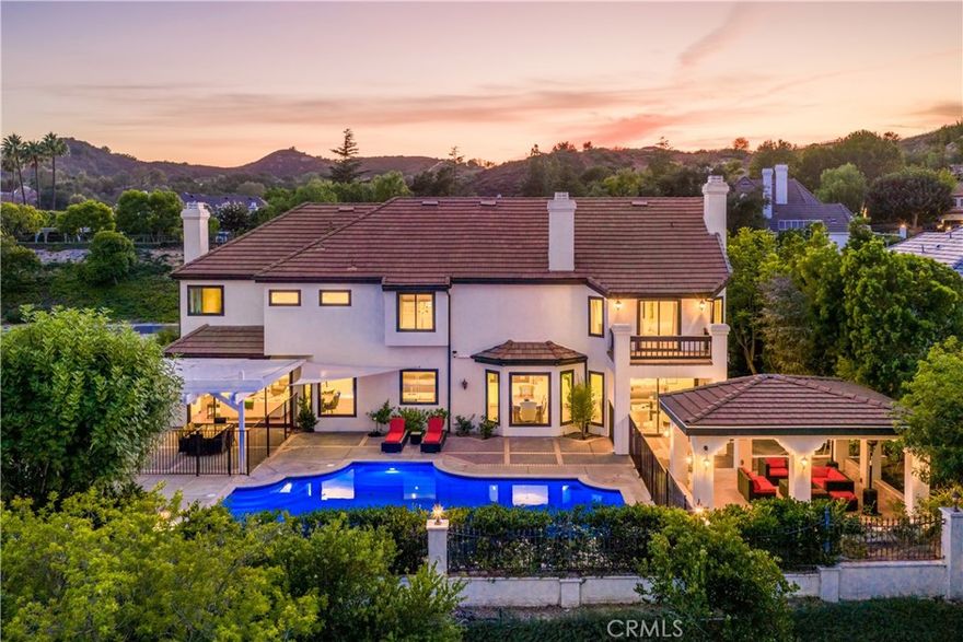 Nestled within the Forest section of the guard-gated community of Coto de Caza, this extensively upgraded custom home is an unmatched retreat. Set on an impressive, approx. 19,000 square foot lot situated on a single loaded cul-de-sac street behind its own gate, it offers privacy, panoramic views of the surrounding landscape, and luxurious, recently updated interiors. Spanning nearly 6,000 square feet of living area, this comprehensively remodeled residence features five bedrooms, including one on the ground level, five and a half baths, an office, and a den. Grand in scale, the floor plan encompasses formal sitting and dining areas as well as a more casual great room with a living section and the home’s all-new gourmet kitchen. This gourmet space with dual islands is complete with custom cabinetry, finishes, and a suite of top-of-the-line appliances. A fully built out pantry with additional storage, a sink and dishwashers complements the culinary haven. Accessed via oversized doors, the property’s stunning backyard with multiple seating sections is centered around the saltwater pool and spa. Ideal of enjoyment of the outdoors year round, this private space features a covered gazebo and an elevated viewing area for taking in the stunning vistas. The primary suite is located on the upper level - fully remodeled, it offers a balcony, a newly built out closet and a luxurious bathroom Clad in marble, this serene oasis with double vanities, a jetted tub, and a massive walk in steam shower is truly tranquil. The remaining secondary bedrooms are ample in size, with corresponding baths and walk-in closets. Whole house updates include a new HVAC system, water filtration, updated piping, new windows, doors, and walnut as well as marble flooring throughout. Coto de Caza’s residents have access to extensive amenities, including horse trails, a clubhouse, a state-of-the-art gym, and multiple pools in addition to tennis courts and two championship golf courses designed by Robert Trent Jones Jr. All of this just minutes away from area’s finest shopping and dining!