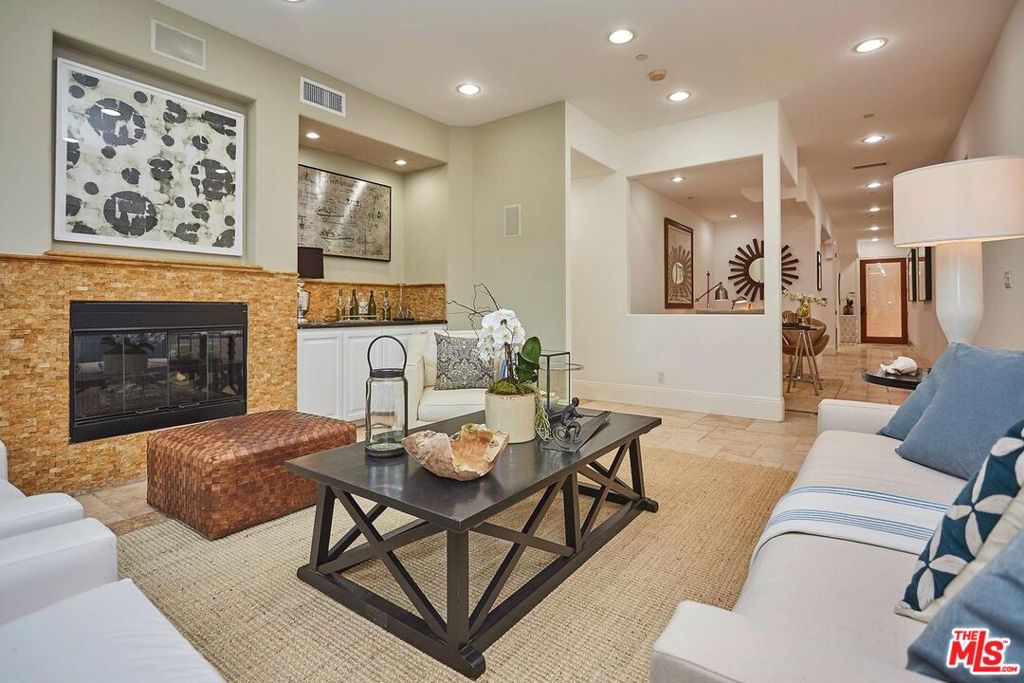 Cozy & luxurious opportunity to live in Pacific Palisades. This beautiful condo feels like a house! All on one level, spacious open and bright with foyer entry, updated kitchen with stainless steel appliances, new built-ins, formal dining room and an open office space. High ceilings throughout, natural stone and hardwood floors, refined living room space with custom fireplace and surround sound. The primary bedroom has a private balcony with 2 walk-in closets and resort like primary bath. 2 more large bedrooms with another full bath and powder. Fully equipped gym, Rec room, close to the Village and hiking trails, minutes from the Pacific Ocean. A wonderful opportunity to reside in the Palisades while rebuilding your home.