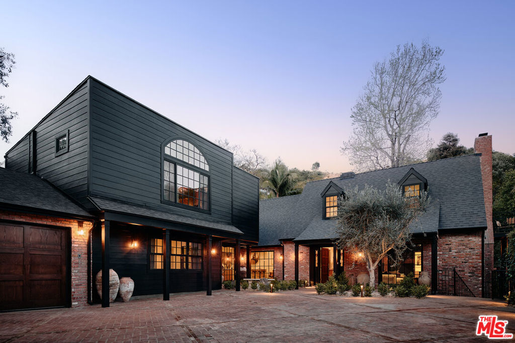 Reimagined by House of Rolison, this gated Sunset Plaza retreat blends historic charm with bold, modern drama, creating a home that feels both curated and effortless. Set securely behind gates and a private brick motor court with ample parking, the residence unfolds in layers of reclaimed materials, heritage details, and contemporary updates that give the home a rare balance of character and ease. The skylit kitchen is a centerpiece, finished in striking Viola marble and custom oak cabinetry, with new, top-of-the-line appliances seamlessly integrated throughout. A custom bar anchors the formal living room, while dining and lounge areas shift between moody and bright, including a warm living space centered on a statement fireplace framed in Delft tile. Upstairs, the secluded primary suite offers a retreat of its own, tucked away to create a sense of privacy and calm. Finished with tailored details and a spa-like bath, it's designed as a personal sanctuary above the city. Each of the home's four bedrooms includes its own en suite bathroom, with a total of five baths providing both comfort and privacy for family and guests. A rare lower-level basement provides additional storage or utility space, a practical bonus in the Hollywood Hills. Outdoors, the property is designed for entertaining and everyday living, with a full outdoor kitchen, pool, spa, wood-burning fireplace, and a lower yard surrounded by mature landscaping. This is House of Rolison reimagined living, a home where character is preserved, spaces are elevated, and every detail feels intentional. A rare gated offering in the Hollywood Hills, 1524 Sunset Plaza stands as both a sanctuary above the city and a showcase of design-driven living, just minutes from the Sunset Strip.