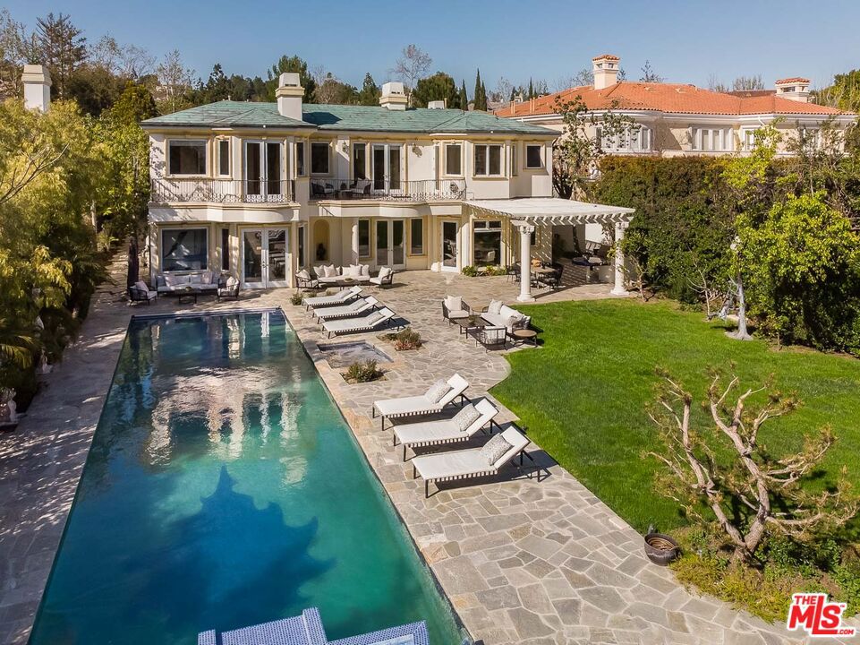 24HR guard-gated security, an 18,000sqft flat useable lot, and one of the best backyards in Bel Air Crest makes this the offering you've been searching for! This elegant Hamptons styled Traditional features an impressive ambiance, dramatic volume and scale, soaring ceilings, and a bright open flow with an exceptional 2-story, 8,000sqft 7BR, 7.50BA floorplan. Rarely found, the layout features 5 UPSTAIRS bedroom suites with baths, downstairs staff room (6thBR), an impressive, jaw-dropping entry, grand formal Living Room, Dining Room & Family Room, richly appointed Library/Office, and an extra bonus room ideal for a pool table or space for a media room or children's play area. The serene poolside Gym with bath makes exercising enjoyable, and could also become a huge 7th downstairs bedroom suite! You'll love stepping straight out to the flat park-like backyard featuring expansive grassy areas, 60ft pool with fountains, large entertainers' patios, BBQ Bar, spacious lounge areas and total privacy. Charming kitchen with butlers pantry and adjacent Family Room open straight to the yard. The main bedroom suite includes a large sitting room, terrace, spacious bath with dual amenities, dressing room, and oversized walk-in closet. All bedrooms are ensuite and include generous walk-in closets. A gracious circular stairwell plus a back staircase provides easy flow. Wood floors throughout the entire 2nd floor. Architectural skylights fill the interior with natural sunshine throughout the day, 2 laundry rooms on 1st and 2nd floor, and a tranquil, quiet cul-de-sac location completes this exceptional offering. BEL AIR CREST offers resort-like amenities in one of the most sought after 24HR gated enclaves in LA. Monthly HOA dues include the 24hr guard gated entrance, community pool, tennis courts, children's playground, large clubhouse with fitness center, basketball, putting green and even a dog park!
