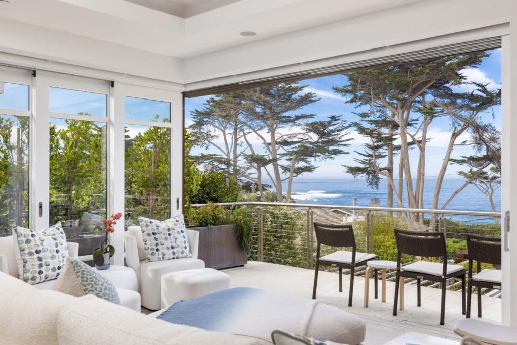 A spectacular newly built home in the heart of downtown Carmel's Golden Rectangle, where modern architecture meets coastal elegance. Designed with meticulous attention to detail, this contemporary residence offers three bedrooms, two and a half bathrooms, and an additional office/den. Sleek finishes augment large windows that display ocean views and the natural beauty of the surrounding area. The primary suite is a tranquil retreat with a spa-like en-suite bathroom and access to a beautifully landscaped, private yard with a covered patio and fireplace, hot tub and separate fire pit. Two additional bedrooms provide comfortable and private spaces for family or guests. Whether you're enjoying morning coffee or entertaining guests, this outdoor space is perfect for soaking in the serene surroundings and the sound of crashing waves. This home embodies the best of Carmel living, offering both modern luxury and an unbeatable location just moments from world-class dining and shopping, or taking a stroll on Carmel Beach.
