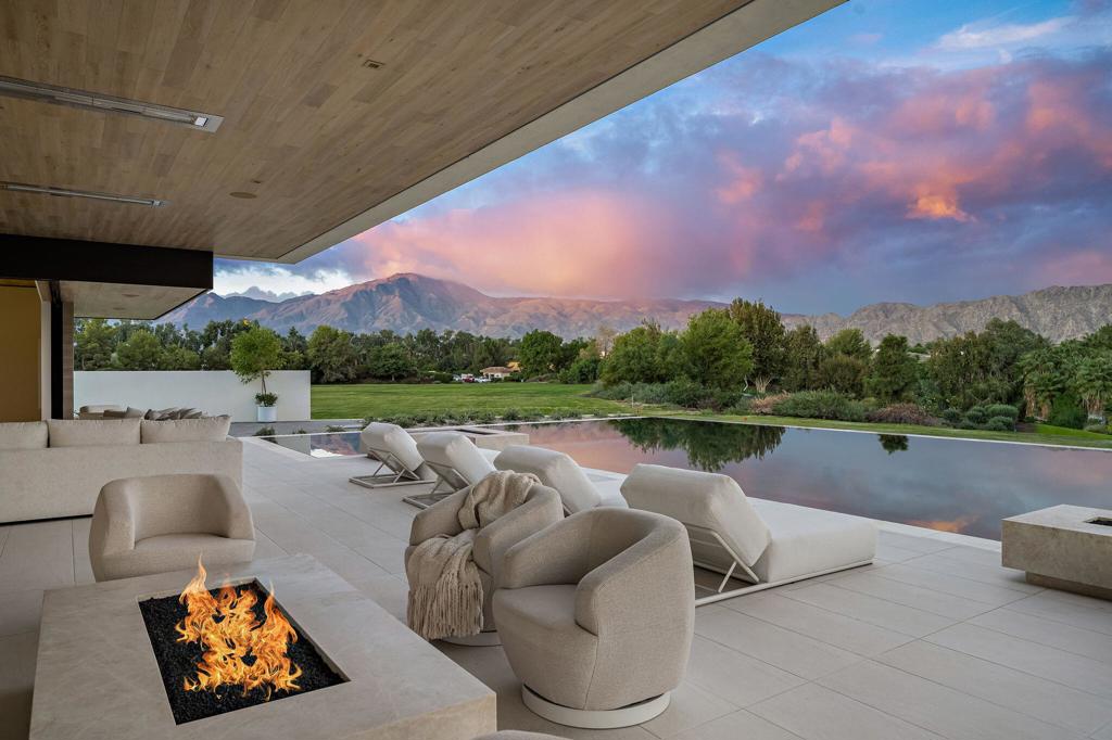 Breathtaking views of the Santa Rosa mountains greet you as you enter the courtyard of this Custom Home perched above the 15th tee box of the acclaimed Tom Fazio course. The dramatic great room boasts soaring ceilings that frame the western views across the custom infinity edge pool. Totaling 13,043 Sq. ft, this home features 6 bedrooms 6 full and 3 half baths, office, 3 pools, wine room wall, 2 bars, 2 custom three-sided fireplaces and 4 top-of-the-line chef's kitchens. The game room with custom Mario Romano wall, pool table and custom bar opens to the courtyard water feature and pool to provide entertainment for all ages. The primary retreat is truly unique with its spa-inspired bath with private pool and firepit.There are 2 casitas, each with its own living area and kitchen which offer your guests their own private get-away.