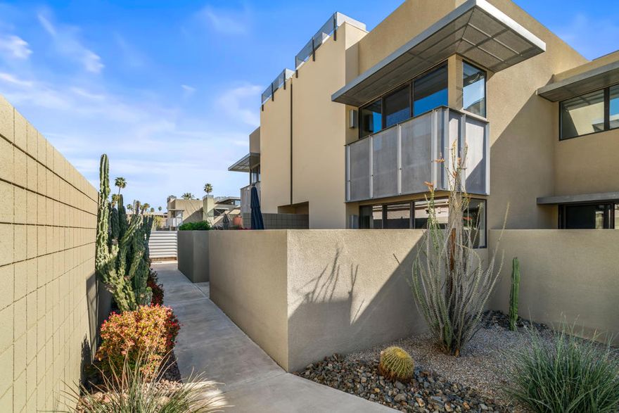 Introducing 48@Arenas - an enclave of contemporary townhouses nestled in the heart of Palm Springs, mere moments away from the vibrant Arenas District and an array of upscale dining and shopping destinations Downtown. Step into your own private oasis as you enter this sleek and modern home, where a welcoming patio sets the tone for the indoor-outdoor lifestyle that defines Palm Springs living. The main level boasts an open-concept design, seamlessly connecting the kitchen, living, and dining areas, all accentuated by expansive sliders that frame stunning mountain views and the serene Western-facing patio. A half bath and utility area round out the convenience of the main level. Upstairs, two serene ensuite bedrooms offer unparalleled privacy for both owners and guests. The primary, with its majestic mountain vistas and a charming Juliet balcony, serves as a luxurious retreat, while the cheerful morning light of the guest ensuite creates an equally inviting ambiance. Storage abounds throughout the home, complemented by a community bike room and convenient carport parking just steps away from the kitchen. Enjoy resort-style living with access to four pools and spas, all within a secure gated community where you own the land outright. Don't let this opportunity slip away!