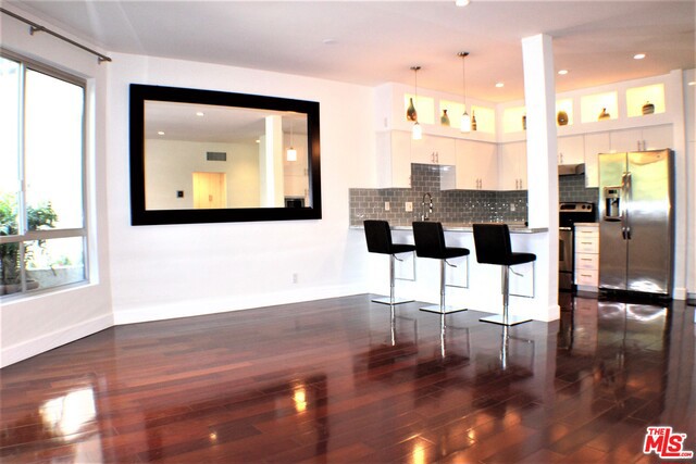 Gorgeous Designed unit of 1 bed 1 bath 2 ( "TWO" ) SIDE BY SIDE PARKING with huge storage attached to each parking space, A Designer's Dream Condo that could turn be Your Future Home, Located in PRIME West Hollywood Norman Triangle area at only one block from Beverly Hills, ALL New with Wood Floors, Gorgeous Updated Kitchen with Custom Built-ins & backsplash, Breakfast Bar, High-End GE Stainless Steel Appliances and Wine Fridge, Spacious Master with Custom Cedar lined Walk-In Closet, Beautiful Designed New Bathroom. This Unit is Completely Redone from top to bottom Everything is NEW, New Central A/C & Heater, New Windows throughout. New INSIDE UNIT WASHER & DRYER, New Modern Fireplace, Private Balcony Great Lighting in an Elevated first floor (three stories building), one minute to Robertson Blvd ,Santa Monica Blvd and Sunset Blvd . Quiet Area Completely redone Building amenities include HOA dues (w/ EQ INS!), Sparkling Pool, Gated Garage and Controlled Access. Come and See it !