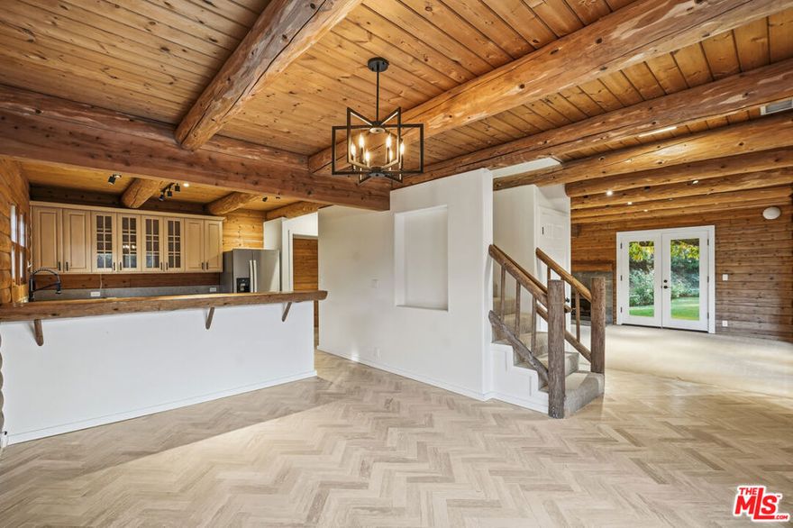 This updated 4 bedroom, 3 bathroom Malibu lease offers a truly unique log cabin retreat tucked into the Santa Monica Mountains, adjacent to the iconic Calamigos Ranch. With access to the ranch's public grounds and the Gentry Market, the property promotes a blend of tranquil surroundings and everyday convenience. Inside, the cabin features wood craftsmanship throughout the 3 bedroom and 2 bathroom upper levels, including an oversized living room with fireplace and a beautifully tiled kitchen with upgraded appliances. The primary bedroom presents its own fireplace, walk-in closet and tiled shower, while large sliding glass doors open to an oversized balcony with views of the mature oak trees and flowing creek nearby. The lower level has been fully renovated into a 1 bedroom, 1 bathroom apartment with its own entrance, including a spacious living room, open kitchen and plenty of room for storage. The grassy backyard invites outdoor gatherings with ultimate privacy along with ample parking. Perfectly positioned halfway between Malibu's pristine beaches and the shopping and dining hubs of Westlake Village and Agoura Hills,. The property combines natural surroundings with everyday practicality, offering a balanced lifestyle of mountain calm and coastal access.