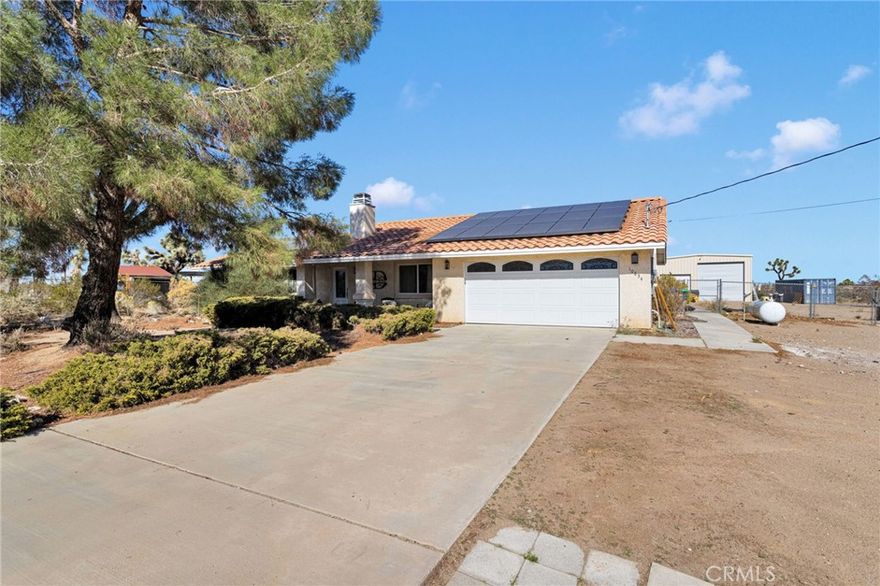 !!!!PAID SOLAR!!!!
Rare High-Desert Modern Farmhouse Retreat on 1.14 Acres – Privacy, Upgrades, and Resort-Style Living!

Step into a rare High Desert treasure a spacious and private sanctuary set on 1.14 acres border-lining Phelan, Oak Hills, and Victorville. This beautifully designed 4-bedroom, 2-bath home offers approximately 2,148 sq ft of living space and comes with PAID SOLAR, giving you comfort and efficiency.

From the moment you arrive, the charm begins: a gentle desert breeze greets you on the welcoming front porch. Inside, the open living area is anchored by a cozy wood-burning stove. New tile flooring throughout enhances the clean, cohesive modern-farmhouse feel.

The kitchen is a true centerpiece, offering stainless steel appliances, a movable center island with wood countertop, double oven, cooktop, dishwasher, microwave, and abundant cabinetry finished in a stylish distressed look. With views of the expansive backyard, the kitchen seamlessly blends indoor and outdoor living ideal for entertaining or everyday comfort.

The primary bedroom has been thoughtfully expanded into a truly luxurious suite, featuring 2 walk-in closets, a fireplace, and a beautifully upgraded ensuite complete with double sinks, a vanity area, and a walk-in shower. The additional three bedrooms are generously sized, and the second bathroom features a spacious layout with a shower/tub combo and tile countertops. The laundry room is conveniently tucked away in its own dedicated closet.

Step outside and embrace resort-style living: a sparkling in-ground pool with rock slide, spa with a grotto waterfall, and an expansive patio area ready for gatherings, barbecues, or quiet relaxation. For hobbyists, car lovers, or RV owners, the property includes a massive 30' x 40' detached RV garage/workshop with a 14-ft high door, 50 amp plug for RV or compressor/welder, and a 100 amp service panel. The home is also equipped with a generator switch, offering peace of mind and backup power when needed. A 12 x 20 shed. The entire property is fully fenced with plenty of space for kids, pets, toys, or future additions. 

Located near Baldy Mesa Rd in the highly desirable Snowline School District and offering quick access to Phelan Rd and the freeway, this home delivers the perfect blend of privacy, space, style, and convenience. Enjoy wide-open skies, unforgettable desert sunsets, and the freedom to stretch out in a place that feels like your own private retreat.