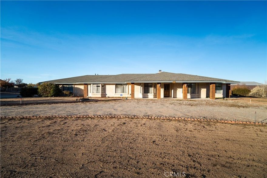 Discover this Beautiful Custom Home in the Highly Desired Community of Oak Hills, offering 4 Bedrooms, 3 Bathrooms, and nearly 2,600 SqFt of Quality Craftsmanship on a Spacious 2.35 Acre Lot. **DOUBLE-WIDE RV GARAGE / 1,200 SqFt WORKSHOP!**

The property includes a Huge 1,200 SqFt Double-Wide RV Garage/Workshop — perfect for RVs, Boats, Trailers, Equipment, and all your Toys.

The Kitchen features Ample Cabinetry, a Breakfast Bar, and a Bright Breakfast Nook overlooking the property. Just off the Kitchen is a Formal Dining Area perfect for gatherings, along with a Warm, Inviting Sunken Den that offers a cozy space for relaxing or entertaining.

A Standout Feature of this home is the Private Maids Quarters — a Separate Bedroom and Bathroom located off the Laundry Room with direct access to the Kitchen and Garage. This versatile space is ideal for Multi-Generational Living, a Guest Suite, Caregiver Quarters, Office, or In-Law Setup.

The Primary Suite offers a Spacious and Comfortable Layout complete with its own Fireplace and a Beautiful Bay Window Sitting Area with a Built-In Window Seat — a perfect spot for reading or unwinding. The Ensuite includes Dual Sinks and a Walk-In Shower. All additional Bedrooms are Nicely Sized with Great Closet Space and Natural Lighting.

Outside, the Expansive 2.35 Acre Lot provides Endless Possibilities. A Circular Driveway welcomes you home and leads to the Oversized 3-Car Garage, featuring Floor-to-Ceiling Storage Cabinets for Exceptional Organization. Paired with the Huge Double-Wide RV Garage, this property also includes the Spacious 1,200 SqFt RV Garage/Workshop, offering Outstanding Space for Multiple Vehicles, RVs, Boats, Trailers, Equipment, Storage, or Workspace Needs. Additional updates include a Roof replaced approximately 2016–2018, offering peace of mind for years to come.

Enjoy the Peaceful Country Setting, Beautiful Desert Views, and the Open Space that Oak Hills living is known for, all while being just minutes from the 15 Freeway. This Custom Oak Hills Property offers Quality Construction, Unique Features, and Usable Acreage — a wonderful opportunity to enjoy Comfort, Privacy, and Room to Grow.

Don’t miss this Exceptional Home!