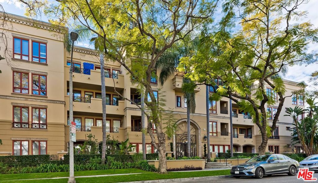 Nestled on a picturesque, tree-lined street in Beverly Hills, this stunning corner unit at The Oakhurst epitomizes luxury living. Spanning approx. 1,850 sf, this exquisite 2-bedroom, 2.5-bathroom residence is a rare gem in one of the area's most coveted buildingsboasting a 24/7 doorman/concierge, security, guest parking, and more. Step inside to an expansive layout where the living room, dining area, and gourmet kitchen blend seamlessly, creating the perfect flow for both everyday living and entertaining. The kitchen is a chef's dream, featuring stainless steel appliances, double ovens, and a charming breakfast nook. A built-in bar and cozy fireplace elevate the ambiance, while the oversized outdoor patio invites you to unwind or host guests in style. The primary suite is a private sanctuary, complete with a secluded balcony, dual closets, and a spa-inspired en-suite bath featuring dual sinks, a walk-in shower, and a separate soaking tub for ultimate relaxation. The second bedroomcurrently used as a denoffers incredible flexibility and can easily be converted into a full bedroom as needed. Designed for convenience and comfort, this home also includes in-unit laundry, central heating and air, two side-by-side parking spaces plus an additional spot, extra storage, and ample guest parking. Perfectly positioned just moments from the Golden Triangle of Beverly Hills, this residence offers effortless access to an array of premier destinationsBristol Farms, Cedars-Sinai, the Beverly Hills Farmers Market, and the high-end boutiques and acclaimed restaurants of Robertson, Melrose, and Beverly Blvd. Experience elevated living in the heart of Beverly Hillsthis is the lifestyle you deserve!