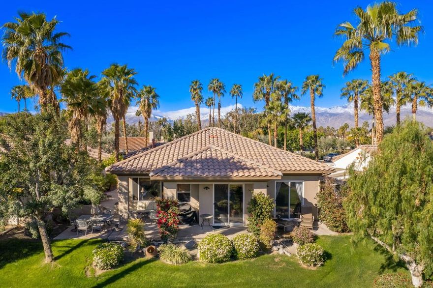 Lakefront  with Spectacular Views,  Great Curb Appeal, Popular Open Floor Plan and located near Mission Hills Country Club Sports Clubhouse with Tennis/Pickleball Membership Included.  Enter through Gated Courtyard with outdoor living and mountain views.  Entry Hall leads to Open Great Room with fireplace Kitchen and Dining area all with great views of the lake and fountain. Social Kitchen features granite counters and island with counter seating. Dining area and Entertainer's Bar overlook the lake views.   Primary Suite has Retreat area overlooking the lake and Primary Bath featuring dual vanities with marble countertops, shower and a soaking tub.  Extra large Primary Closet has custom built-ins. Guest Suite is like a casita with a slider to the courtyard terrace, an ensuite bath and walk-in closet. Second Guest Bedroom and bath nearby give room for friends and family or an office. Outside are expansive lakefront terraces for dining and living and courtyard with mountain views.   Mission Hills Country Club Sports Membership included in HOA (tennis, pickle ball, croquet, gym, social).   Great value at this price - come home to your lakeside desert retreat!