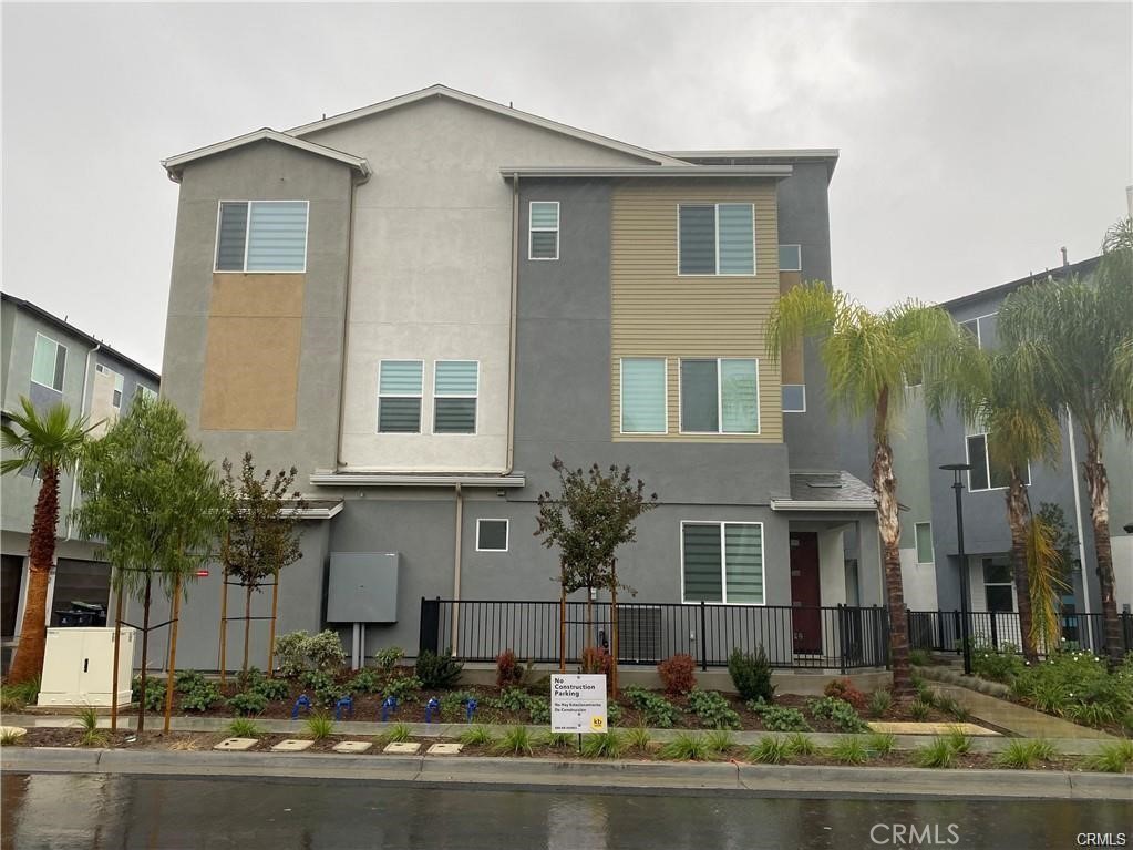 This property is a modern, three-story condo built in 2022, located in the Lacy Crossing community in Santa Ana. It's a spacious and thoughtfully designed home, great as a family home or rental investment. It combines comfort, convenience, and value in a desirable neighborhood. Its size is approximately 2139sqft across three levels, 4 bedrooms, and 3.5 bathrooms with Paid-off solar panels-reducing electricity expenses and enhancing sustainability. The 1st floor has a private suite with bedroom, full bath, and walk-in closet, ideal for a guest or an office. The second floor has an open-plan great room offering abundant natural light and a kitchen, including a walk-in pantry, offering extra storage space for food, small appliances. The third floor features three bedrooms and two full bathrooms