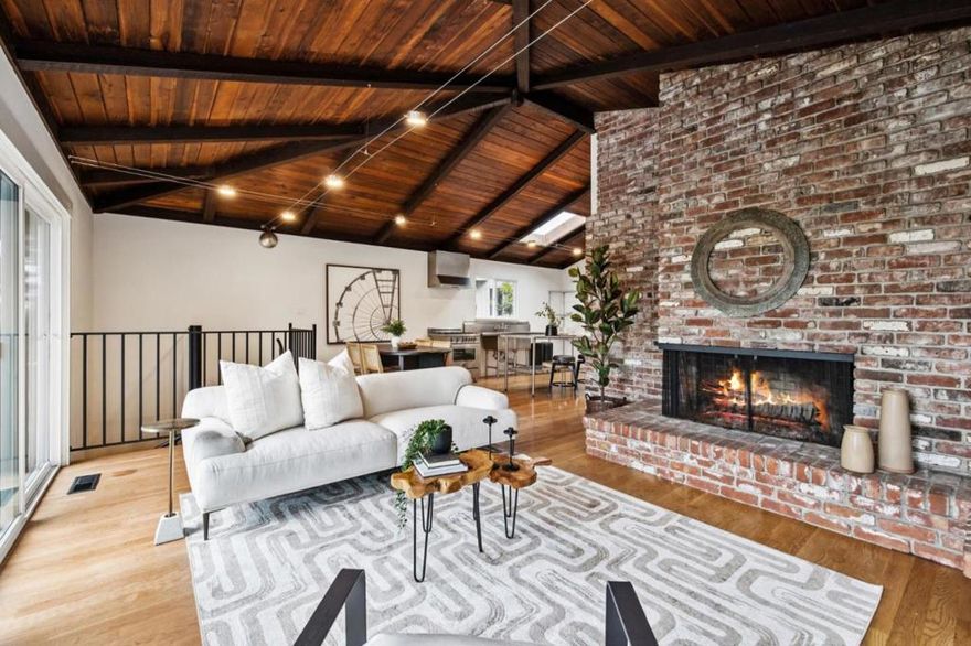 Exceptional Portola Valley bungalow located in Woodside Highlands. This charming 2-bedroom, 2-bath home with a den offers 1,430± sqft of living space on a generous 13,507± sqft lot surrounded by nature. The home features an inviting floor plan with open-beam ceilings and a large wood-burning fireplace that creates a warm and welcoming atmosphere. Upstairs, find the primary suite with a walk-in closet and sliding doors that open to the deck. The den provides flexibility for a home office or creative space. Upstairs is finished with an updated bathroom and a kitchen with stainless steel appliances. A striking spiral staircase leads to the lower living area, where you'll find a spacious family room with a cozy fireplace perfect for relaxing or entertaining. Downstairs find a bedroom and a modern bathroom. Enjoy the seamless connection to the outdoors with private patios and garden areas offering peaceful views of the natural landscape. Additional highlights include a carport with a large storage room underneath. Enjoy easy access to Hwy 280 for all your Bay Area commutes. Located in a tranquil, sought-after neighborhood near scenic trails, local shops, and top-rated Portola Valley schools, this home captures the best of California living.