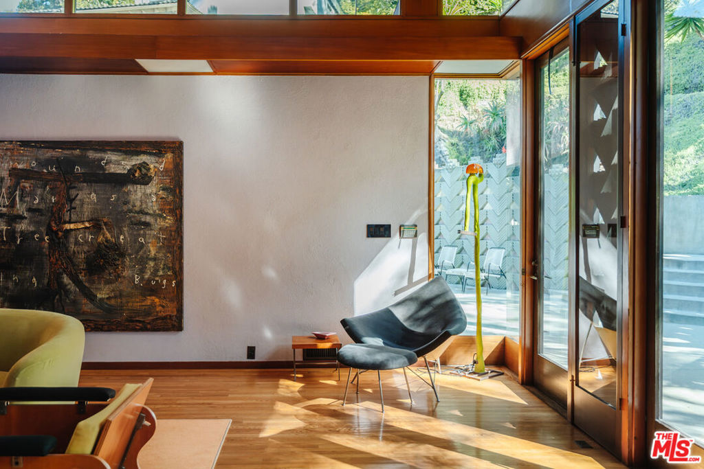 A once-in-a-lifetime opportunity to acquire the legendary David Lynch Compound: a private 2.3-acre hillside enclave that unites architectural pedigree, cultural history, and cinematic mythology in the heart of the Hollywood Hills. Anchoring the estate is the Beverly Johnson House, designed in 1963 by Lloyd Wright, son of Frank Lloyd Wright. Recognized by Historic Places LA as an "excellent example of Mid-Century Modern/Organic residential architecture," the house embodies the drama of hillside modernism with bold geometry, walls of glass, and a seamless flow between indoors and out. Over the years, Lynch expanded the property into a true compound by acquiring the two neighboring residences on Senalda Drive. At 7029 Senalda, he established the address for his production company, Asymmetrical Productions. At 7035 Senalda, he found cinematic inspiration in the home, later immortalized on screen as the Madison residence in Lost Highway (1997), which includes Lynch's private editing suite and screening room. Lynch commissioned Eric Lloyd Wright in 1991 to design a pool and pool house, extending the site's rare multi-generational Wright lineage. The director also collaborated on the creation of additional structures on the property, including a two-story guest house and another unique one-bedroom living space finished in his favored smooth grey plaster. Together, the three residences and ancillary structures form a cohesive, secluded compound of 5 contiguous parcels. A creative sanctuary and architectural landmark offered with a provenance unlike any other in Los Angeles.