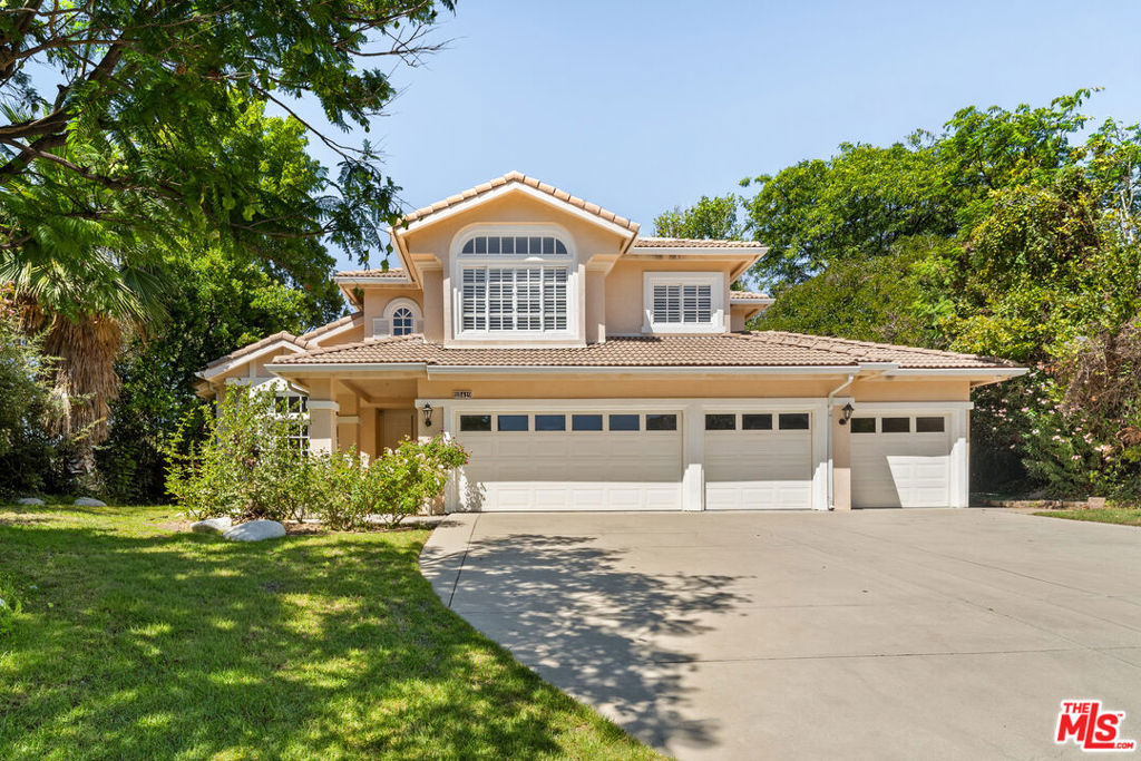 Set within the coveted guard-gated community of Silverhawk Estates in the Tarzana Hills, this remodeled residence offers a refined blend of scale, comfort, and design. A grand entry foyer introduces the home with soaring ceilings, porcelain floors, and oversized windows that bathe the interiors in natural light. Multiple living areas provide distinct settings for gathering and relaxation, seamlessly connecting to the outdoors and framing verdant views.The chef's caliber kitchen is centered on a generous eat-in island and outfitted with stainless steel Miele appliances, designed to serve both everyday living and larger entertaining with ease. A formal dining room complements the space, creating a natural flow for hosting. The home's private quarters include well-appointed guest rooms and a spacious primary suite defined by vaulted ceilings, a custom walk-in closet, and a spa-like bath with dual marble vanities, soaking tub, and oversized glass showerall oriented to lush garden outlooks.Outdoors, the grounds unfold like a private resort. Expansive patios and lawns surround a sparkling pool and spa, with a firepit, full outdoor kitchen with bar, and abundant space for both large-scale entertaining and quiet retreat. Additional features include a Control4 smart system with integrated audio, a laundry room, and a three-car garage with additional parking for four or more vehicles. Ideally located just moments from Braemar Country Club, nearby parks and hiking trails, and the premier shopping and dining of Ventura Boulevard, this residence offers both privacy and convenience in one of Tarzana's most sought-after enclaves.