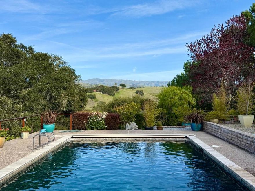 First time on the market! This beautiful, sunlit home in the hills overlooking Corral De Tierra, has 5 bedrooms, 2.5 baths, 2680 sq ft and sits on a 4.3 oak studded acres with marvelous views of Mt. Toro in the distance. The home has wonderful natural light that greets you as you enter the front door to the central atrium.  The formal living room has oak floors, a redwood fireplace and wraparound deck that looks across the green hills to Castle Rock. The primary suite has high ceilings, a walk-in closet and redwood bathroom, with a shower and sunken bathtub that look onto the atrium.  The kitchen and family room overlook the pool with oak trees that frame Mt. Toro in the distance. The kitchen has been updated with limestone countertops, large kitchen sink, new faucet and appliances. The flooring is interwoven with tile and wood. There is a formal dining room that also looks onto the central garden. The wing next to the family room has four bedrooms with views. The bathroom has redwood walls and vintage ceramic tiles in the shower and around the two sinks.  The home has solar, a greenhouse and two car garage with space for a workshop. This home is ready for its next owner to move in and enjoy the sun, lifestyle and marvelous views that this home in Corral De Tierra has to offer