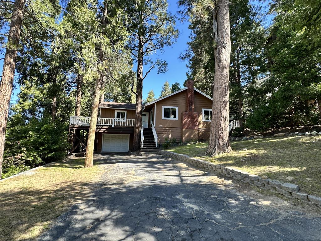 Nestled near the end of a peaceful road, this inviting mountain retreat is the second to last house before forever forest and sweeping valley views-perfect for enjoying breathtaking sunsets. Step into a spacious, pine-paneled family room with a classic brick hearth and abundant windows that bring in natural light. The open great room seamlessly blends living and dining areas, flowing into a hands-on kitchen ideal for everyday living and entertaining. The generous primary en suite offers a full bath and over sized walk-in closet. Two additional bedrooms provide space for guests or work-from-home needs. Enjoy the convenience of an attached single-car garage, fenced backyard, large deck, under-house storage, and a standby Generac generator for peace of mind. This home checks all the boxes for mountain living: privacy, space, and captivating views. Probate sale-court approval required.