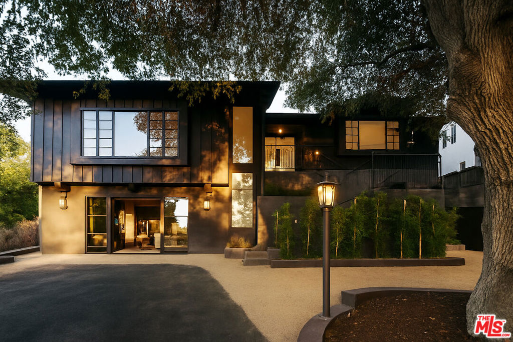 A rare opportunity to own a home originally envisioned by the owner for himself a one-of-a-kind, custom-built residence crafted with top-tier materials and uncompromising attention to detail. Currently undergoing a full-scale transformation, the 5-bedroom, 5-bathroom home also includes a junior ADU with its own 1-bedroom suite and flex space, perfect for guests, work, or extended living.A Reimagined Architectural Gem- transformed into a bespoke modern sanctuary where materiality and craftsmanship take center stage. Anchored by Cipollino Italian marble slabs in the kitchen and baths, the home exudes understated luxury with honed marble tile, custom plaster finishes, and handcrafted white oak cabinetry throughout.The entry, kitchen, and living spaces feature seamless micro-cement flooring, transitioning effortlessly into wide plank wood floors that extend through the rest of the home. A chef's kitchen is appointed with a full suite of Thermador panel-ready appliances and a 48-inch Italian range, all framed by custom built-ins and striking brass cylinder lighting.Natural light pours in through Fleetwood fixed glass and Andersen windows, while trimless recessed lighting and door jambs lend a clean, architectural edge. Elevated design details from the Verde marble integrated sink and marble-wrapped soaking tub to the handmade Belgian iron pulls and Emtek hardware reflect the home's curated aesthetic at every turn.The exterior is equally refined, finished in troweled plaster with custom iron railings and a terraced backyard designed for outdoor living. An Ipe wood deck unfolds beneath the canopy of a protected mature oak, surrounded by fruit trees and lush landscaping that balances privacy with beauty.
