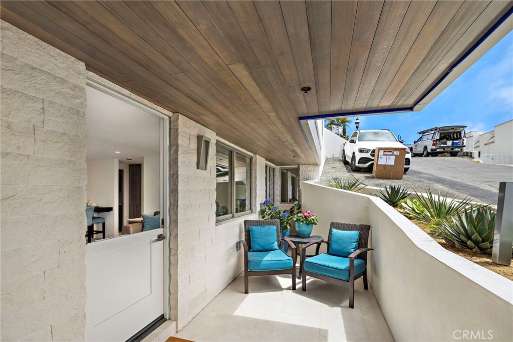 Available for a one-year lease and offered fully furnished, this brand-new high-end residence is ideally located within walking distance to iconic Victoria Beach. A true new construction, the exterior is clad in stacked limestone, while the private patio showcases a wood tongue-and-groove ceiling and honed limestone flooring, creating an inviting sitting area with breathtaking Catalina and ocean views—enjoyed equally from both the patio and interior rooms. Inside, the home is appointed with custom cabinetry, durable leather Taj Mahal quartzite countertops, and upgraded Samsung smart appliances including a refrigerator with filtered water and beverage station, induction range, and oven. All furnishings, electronics, and appliances are brand new and have never been used, complemented by two flat-screen TVs (65” in the main living area and 55” in the bedroom). Thoughtful design details include linen storage, a powder room with floating Toto toilets and Graf hardware, and Restoration Hardware furniture in the bedroom. The primary suite serves as a spa-inspired retreat with dual sinks, a backlit mirror, Lapatech counters, and a walk-in shower surrounded by limestone. A huge custom walk-in closet offers abundant storage with built-in shelving, drawers, and hanging rods. Additional highlights include two split systems for personalized climate control, a laundry closet with LG stackable washer and dryer plus a folding counter with quartzite surface, and cement soundproofing between floors for quiet enjoyment. With approximately 850 square feet of thoughtfully designed living space, utilities and Internet included, and an unmatched combination of comfort and luxury, this exceptional coastal residence presents a rare opportunity in one of Laguna Beach’s most coveted locations.