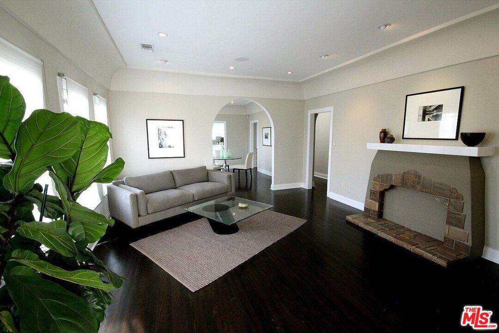 Stunning 1920s Spanish-style 2BR/1BA lower unit (1,700 sq.ft.) in Hancock Park. Renovated with designer finishes: ebonized hardwood floors, crown molding, French windows, limestone bathroom with large walk-in shower (no tub), and gourmet kitchen with slate floors, white glass countertops, and high-end stainless steel appliances. Includes in-unit laundry, central A/C & heat, recessed lighting, built-in security system, and gated shared backyard. Bright, spacious, and full of charm. Minutes to Larchmont, The Grove, Beverly Hills, and major studios.