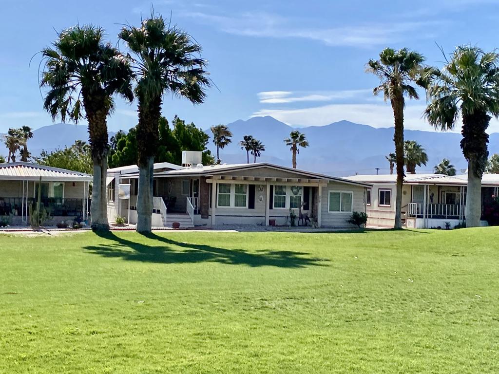 Discover serene resort living in the Hidden Springs golf course community. Large and well maintained 3‑bed, 2‑bath manufactured home boasting 1,856 sq ft of comfortable living space. Living room with vaulted ceilings adorned with English Tudor inspirited beams and views of the manicured fairway. Formal dining area. Long front deck for hosting friends and family at the edge of the golf course. Spacious family room that comes with a wet bar alcove. Kitchen with breakfast bar, stove, stainless steel refrigerator, dual basin sink, pantry, & ample cupboards. Master bedroom with walk-in closet, master bath with raindrop shower, two basin vanity and plenty of cabinets space. Guest bedroom with private door access to the second bathroom. Third bedroom converted to a work shop. Laundry room with office. Storage shed. Carport with two parking spaces. Indoor parking is available for your golf cart. Drive your golf cart to the clubhouse to enjoy the full fitness center, jacuzzi/spa, and pool--all on site. There's more: a community kitchen, picnic and BBQ areas, dog park, garden plots, RV storage, and sport courts including pickleball, tennis, bocce, and shuffleboard. Thoughtfully curated events bring the neighborhood together. Schedule your private tour today to experience firsthand the engaging lifestyle this community provides--you deserve a place that feels like home. (Most of the furniture and furnishings may stay or may be available for negotiation.)