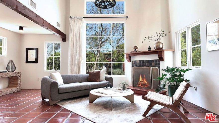 Rare opportunity in West Hollywood's Historic Harper Avenue District!  Dramatic townhome in the highly coveted Spanish Revival 7 Fountains Community, designed by renowned architect Stefanos Polyzoides.  One of only 20 villa townhomes, this private front corner unit  boasts breathtaking wrap around views to the north, south and west. Wake up to living in a beautiful botanical garden-like feel and choose to end your day enjoying a relaxing sunset from your romantic balcony or high in the sky roof deck patio.  Inviting living room with soaring ceiling, grand two-story fireplace and balcony, with views of the Hollywood Hills and city lights.  The open living space incorporates the kitchen, dining area, and powder room, providing a perfect flow for entertaining.  Keep your commute to work short and trouble free.  The separate multi purpose room connected by a private breezeway is the perfect space, replete with views of West Hollywood and into Century City.  Let your imagination run wild and use it as a home office, media room, guest bedroom, yoga studio or...  A beautiful hardwood stairway takes you to the Primary Suite, situated on its own floor with wonderful French doors to Romeo & Juliet balcony, large walk-in closet, plus add'l closet, dual sinks, large tub & separate shower.  Additional bedroom suite on 3rd floor has fireplace, full bath and views.   The 3rd bedroom suite has a romantic Montecito inspired balcony overlooking the Hollywood Hills & Century City. There is a full bath and additional closets.  You will love the outdoor patio deck with sweeping city views including the iconic Mirador sign, beautiful foliage, and all the festivities of West Hollywood and Santa Monica Blvd.  The grounds of the Award Winning 7 Fountains community feature lush landscaping, beautiful fountains, koi pond, seating area with fireplace and peaceful reading room. Each of the 7 fountains features a unique mosaic design, using hand painted tile.  There are 3 separate parking spaces in the garage, huge dedicated storage room, plus plenty of guest parking.  Great location, convenient to award winning shops & entertainment, nightlife and the famous Sunset Strip.  Come spoil yourself!  Don't miss Video and 3D Tours.