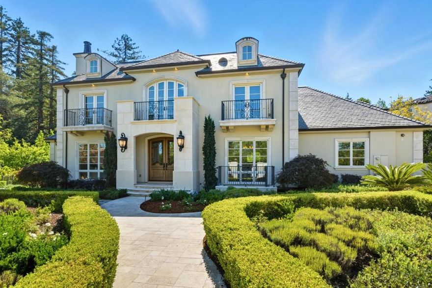 This beautifully designed 5-bedroom, 5 full and 2 half-bath home blends timeless sophistication with modern comfort in one of Hillsboroughs most sought-after neighborhoods. A grand two-story foyer welcomes you in, leading to formal living and dining rooms perfect for entertaining. A private guest suite on the main level adds flexibility, while a butlers pantry hallway and separate walk-in pantry provide smart, functional storage. The expansive great room unites the family area, breakfast nook, and chefs kitchen, opening through folding glass doors to a spacious deck with a tranquil fountain and outdoor fireplaceideal for indoor-outdoor living. Downstairs, a media room with wet bar, temperature-controlled wine cellar, full bath, and additional bedroom offer space to relax and unwind. Upstairs, the luxurious primary suite features a sitting area, two walk-in closets, and a sunlit balcony. Two additional en-suite bedrooms and a handsome wood-paneled office complete the home. Premium finishes include motorized Hunter Douglas blinds and outdoor privacy screens and a full Savant Smart Home System for effortless control of lighting, climate, media, and music.