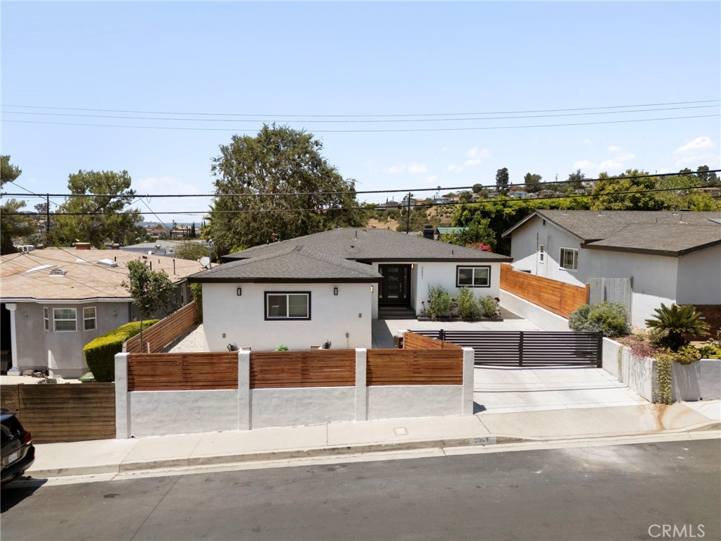 Imagine the fabulous lifestyle awaiting you in this gorgeous, single-story, hilltop home in Eagle Rock! Behind the electric gates is a picture perfect retreat extensively remodeled in 2023 including a stunning kitchen with quartz counters and center island, two contemporary bathrooms, whole house flooring and new HVAC system & ductwork. Entertaining is a joy in the fabulous open floor plan. A great room encompasses the kitchen and living rooms and dining area with added ambiance from the fireplace. The sliding door brings in terrific light and flows to the back yard for alfresco dining. The primary bedroom features a large walk-in closet complete with a custom wardrobe organizer. The luxurious en-suite bathroom has double sinks and a large glass enclosed tile shower. The two other bedrooms overlook the lush rear lawn and share a full bathroom. The laundry room with full-sized washer & dryer is cleverly placed in the hallway with bi-fold barn doors. Step outside to dine on the large concrete pad surrounded by a lush lawn with a sprinkler system, tall hedges and fencing. There are market lights, mature trees and fruit trees adding to the blissful outdoor oasis. Plenty of space for pets and children to play while the completely fenced property provides security. The flat front patio offers a second outdoor entertainment spot, perfect for catching the sunsets! This turn-key property offers newer dual pane windows, a full home rewire, newer 200 amp electrical panel, tankless water heater, EV ready, newer water supply and drain lines. Large two car garage with lots of storage attached to the house. Here's a wonderful opportunity to have it all - a chic, done home near all that Eagle Rock and the trendy communities of Highland Park and Silverlake have to offer. Catch the 2 freeway down the street and ride on over to the nearby neighborhoods of Glendale, Pasadena and La Canada. The community elementary down the road offers a gifted & talented program. Don't miss this special property!