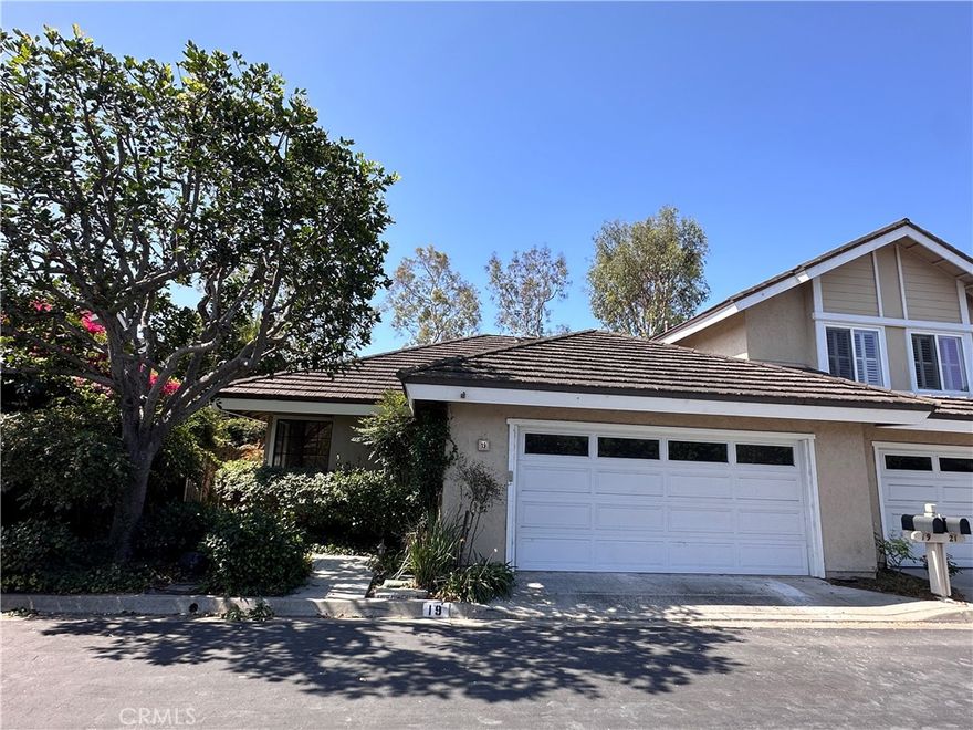 In the heart of Irvine’s famed Woodbridge community, in the boutique neighborhood known as The Grove, and with a backyard gate that opens directly to Ashford Park (with its pool, spas, sport courts, play equipment, and green space) is this SINGLE STORY end-unit home that combines convenience, privacy, and character. Inside, this isn’t a cookie-cutter tract house! Architectural details set it apart — from arched passageways and plank-and-beam ceilings, to a distinctive fireplace with warm wood accents and low-maintenance brick paver flooring playfully sprinkled with colorful tile inlays. Natural light pours in through skylights, while a wraparound yard — designed to feel like an atrium — is visible from the living room, kitchen, and primary suite. The result is a super private outdoor retreat that brings the beauty of the outdoors in, perfect for entertaining or simply relaxing at home. The primary bedroom has an ensuite, freshly remodeled bath featuring dual vanities, quartz counters, and brand-new cabinetry as well as a huge walk-in closet. The secondary bath was updated with the same finishes for a consistent, stylish look. A versatile den space offers an ideal extra area, which could function as a home office, fitness or reading room, or enclose it into a true third bedroom. Fresh paint and new bedroom carpet give the home a bright, welcoming feel right away, while a direct-access 2-car garage and gated front courtyard add everyday convenience and security. As part of Woodbridge, residents enjoy access to two landmark lakes, over 20 pools and spas, tennis, playgrounds, and miles of trails — plus award-winning Irvine schools. With all these great details on a single story, this rare Woodbridge find combines thoughtful updates, timeless character, and one of the most desirable locations in Irvine into a home you can enjoy for the rest of your life!