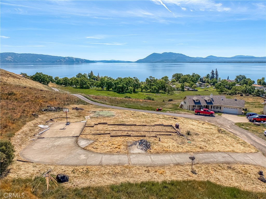 Spectacular 7.4-acre lake view lot in a desirable North Lakeport subdivision. Someone's heartbreak can be your dream come true. A home was built here in 2004 and then lost in a house fire soon after. Now, the heavy lifting is done, and the stage is set for your dream home. With septic, city water, and underground electricity already in place, you can skip straight to the exciting part: designing and building your ideal retreat. Enjoy panoramic lake views, close to downtown, schools, and Sutter Lakeside Hospital, plus the added benefit of deeded lake access. It's a rare blend of convenience, beauty, and potential.
