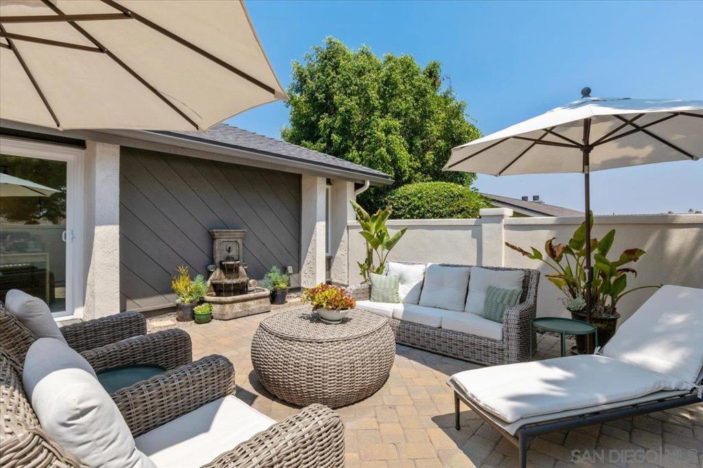 Spectacular designer ranch-style retreat with panoramic views! Welcome to this stunning and impeccably remodeled ranch-style home, where refined design meets everyday comfort. Located in the highly sought-after StoneRidge community, this residence boasts exceptional curb appeal with a private gated front courtyard, elegant paver hardscape, and lush, tasteful landscaping. Inside, the open-concept layout is filled with natural light and thoughtfully appointed with designer-selected colors and finishes. Vaulted ceilings in the dining and family rooms enhance the home's airy, expansive feel. The heart of the home is a show-stopping kitchen featuring rich walnut-stained cabinetry, solid quartz countertops, elegant ivory subway tile backsplash, and top-tier appliances, including a JennAir refrigerator, Bosch six-burner gas range, Bosch double oven, Broan hood, and Bosch dishwasher. A generous island with bar seating and storage connects seamlessly to the dining area, complete with a cozy fireplace and access to the covered backyard patio—perfect for entertaining. The kitchen and dining room feature exquisite Versailles-pattern Turkish travertine flooring, while wood-style tile flows through the living room, entry, and hallways. Statement lighting fixtures enhance the ambiance throughout. Secondary bedrooms include mirrored closets and plush neutral carpet; one is currently outfitted as a home office with built-in cabinetry. (See Supplement) The primary suite is a true sanctuary, offering direct patio access, a custom walk-in closet, a designer vanity, and a spa-inspired bathroom with stunning tilework, a frameless glass shower, and high-end fixtures. Enjoy breathtaking panoramic views from the covered backyard patio—ideal for relaxing or hosting guests. Additional highlights include new roof in 2022, no HOA, and no Mello Roos! Wonderful walking trail system and neighborhood parks in the Farms development nearby. Trails access starts a few homes down on St. Andrews. Local Rancho Bernardo Winery has Friday morning Farmers Market and delightful shops and restaurants.