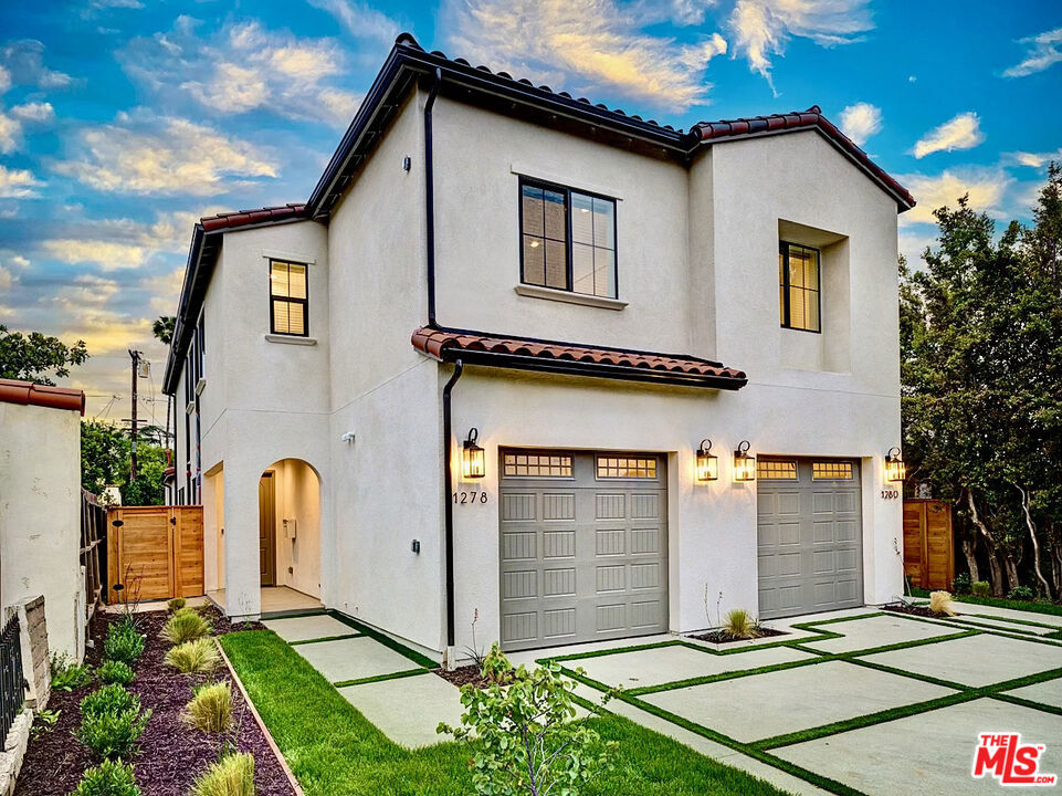 Brand-new 2023 masterpiece crafted by Thomas James Homes, this new construction Spanish contemporary townhome features 2 story, 4 spacious bedrooms and 2.5 tastefully appointed baths. Prepare culinary delights in the chef-inspired kitchen, complete with a walk-in pantry, a generously sized center island adorned with bar seating, and top-of-the-line, new stainless steel appliances, including a Bertazzoni gas range and Frigidaire refrigerator, dishwasher and microwave. The adjacent dining area is an inviting space for entertaining, featuring a chic decorative light fixture that adds a touch of sophistication. Wide plank vinyl flooring, recessed lighting, white shaker cabinets and white quartz countertops, polished chrome plumbing. On the upper level, you'll find three well-appointed secondary bedrooms, thoughtfully designed to accommodate the needs of a modern lifestyle. A bath with a dual-sink vanity and a tub shower serves these bedrooms, while linen cabinetry and shelving in the hallway provide convenient storage. A dedicated laundry closet with side-by-side washer and dryer adds to the home's functionality. Retreat to the luxurious grand suite, a haven of tranquility, the suite features a sumptuous bath complete with a dual-sink vanity, a walk-in shower featuring a comfortable seat, and an expansive walk-in closet that's sure to fulfill your storage desires. Repeat into a private, grassy backyard and BBQ area. Private 2-car garage, with direct private entrance. Additional parking in driveway. Situated in a prime location, this home offers the utmost in convenience, with quick access to Beverly Hills, West Hollywood, and major freeways. Immerse yourself in the epitome of modern living, where thoughtful design, contemporary elegance, and urban accessibility harmoniously come together in one splendid package.