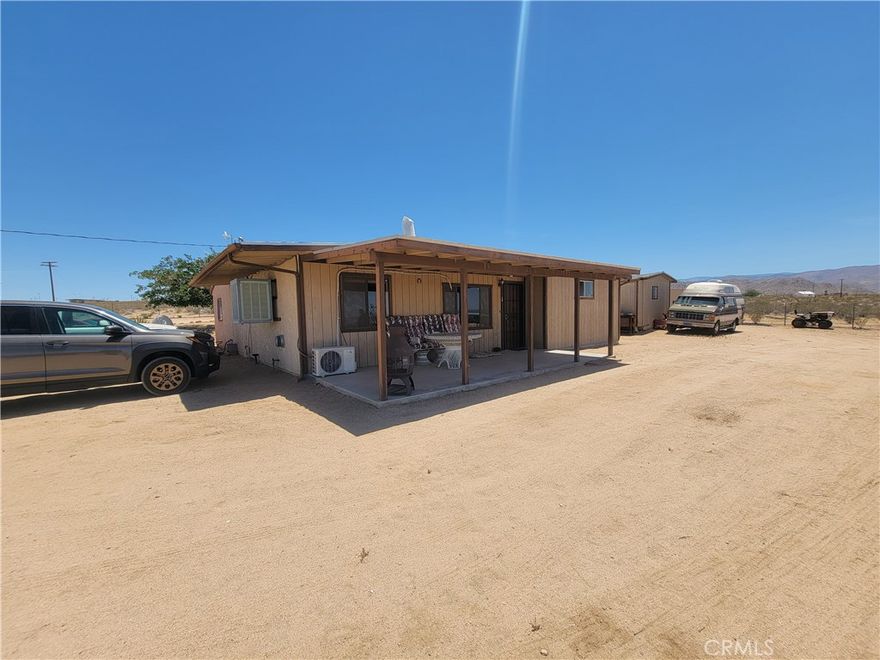 Desert escape, off grid retreat, artist's haven, short term rental investors, remote workers Truckers & Toy Lovers Welcome! Discover wide open space and endless potential on this 5-acre property located in peaceful Johnson Valley. Whether you're a truck driver, off-road enthusiast, or simply crave privacy and room to roam, this property is your perfect match. Plenty of space to park big rigs, RVs, trailers, and all your desert toys. Ideal for weekend getaways, off-road adventures, or building your dream desert retreat. Located near the famous King of the Hammers off-road event area Don’t miss this rare chance to own affordable acreage in the High Desert!  Check out the panoramic mountain views, stunning sunsets, and brilliant star-filled nights. Just a short 20 min drive from Yucca Valley and only 1 block off the main highway 247, it’s your peaceful escape from the hustle and bustle. Inside, you'll find a bright and spacious layout featuring 3 generously sized bedrooms and 1.5 baths. The open-concept great room flows into a sun-filled kitchen, complete with a bay window in the kitchen just perfect for enjoying mountain views while cooking or doing dishes. or just staring out with a cup of hot cup of coffee. Relax on the country-style porch or entertain in your large outdoor spaces. The property includes a four-car garage with a workshop, A must see and must have.