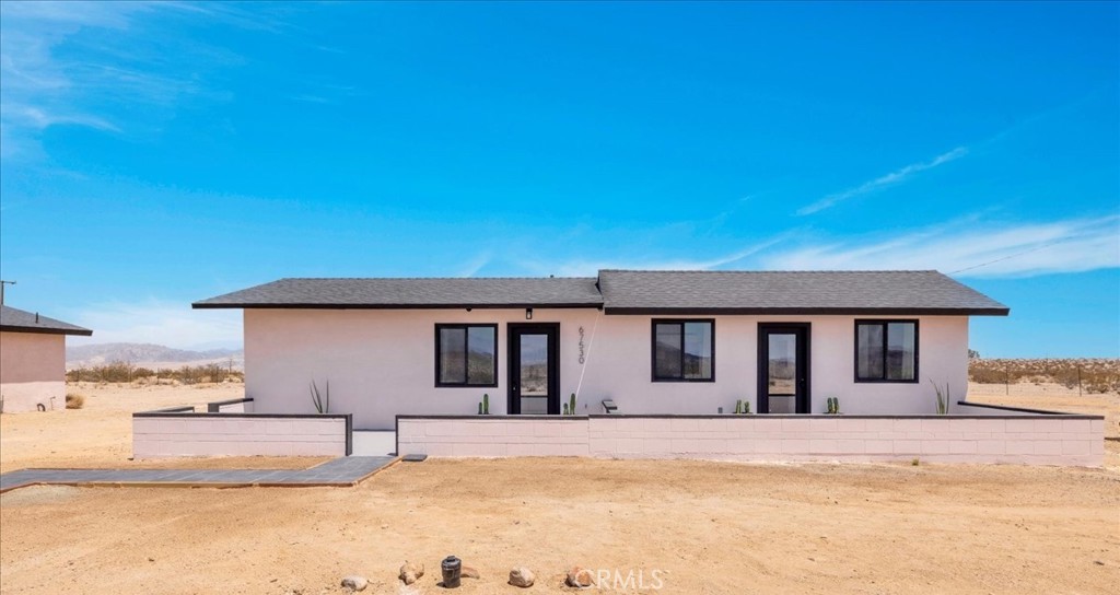 Welcome to 67530 Presswood Rd, a FULLY renovated 2 bedroom 1 bath house on the outskirts of Joshua Tree. This turn-key, modern desert property is nicely situated on 5 ACRES of land with stunning, panoramic desert & mountain views. Featuring 768 sqft of living space, this home has been gorgeously upgraded with every feature intentionally chosen to bring you the perfect airbnb, desert home or weekend retreat. Inside you'll find a bright & lovely living space that adorns warm wood-like flooring, tasteful furnishings/decor, recessed lighting and large windows that let in an abundance of natural light. The kitchen is open to the dining area and features beautiful quartz countertops, sleek white cabinetry, floating wood shelves and lovely tile backsplash. The spa-like bathroom adorns a walk-in shower with a rainfall shower head, contemporary tile flooring, mounted wood shelves and a new vanity, mirror, toilet & fixtures. There are also 3 mini-splits, one in each bedroom & one in the main living area to keep you comfortable year round. Outside you'll be delighted to find a spacious deck that hugs a cowboy pool (the perfect place to soak the day away) and plenty of room to entertain or relax around a Firepit on a starry desert night. Not to mention, NEW roof, NEW septic tank, NEW electrical panel, NEW windows etc. This home can also be purchased fully furnished! A property like this rarely becomes available, come take a look & let the desert's allure do the rest. Your new desert home or weekend retreat awaits!