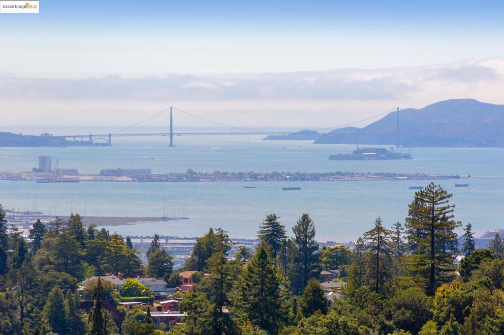 Be prepared to be captivated the moment you step inside this one-of-a-kind, Sea Ranch-inspired modern home. Breathtaking panoramic views of both The Bay and Golden Gate Bridges set the tone, framed by soaring ceilings and warm wooden beams that emphasize the architectural lines and natural beauty of the space. Perched on a sunny hill on a quiet cul-de-sac, this nature lover’s sanctuary is surrounded by majestic oaks and birdsong, nestled in the coveted Montclair Hills. Designed and built in the 1970s by the original owner, the home has remained in the same family ever since. Their artistic vision shines in the primary bath, where sunlight filters through custom stained glass depicting serene natural scenes. Crafted to embrace the landscape and ever-changing views, the home features three levels of decks—plus a rooftop deck perfect for watching sunsets over the entire Bay and San Francisco skyline. The spacious primary suite opens to an expansive deck from both the bedroom and bath, blending indoor comfort with outdoor serenity. Additional highlights include an open floor plan, cozy fireplace, updated kitchen with new appliances, a dedicated study and a meadow of meandering garden flowers below. Settle in, unwind, and watch the hawks soar by—you are home! Views: Downtown