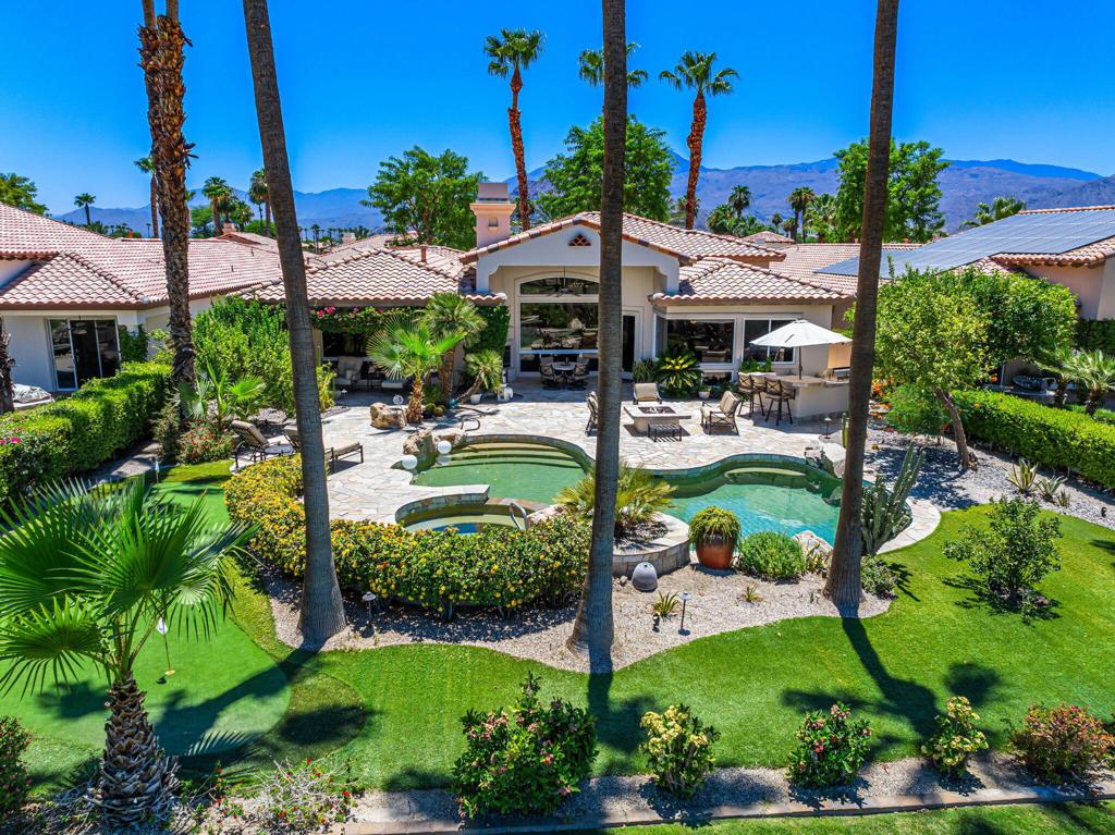 Rare Montana 2 model in the prestigious Rancho La Quinta CC on a oversize lot with magnificent views over a lake, golf course and mountains. This 4 bedroom 4.5 bath home has many Hi end improvements with most A/C's and heaters upgraded and replaced in the last couple of years. Great open floor plan with beautiful travertine floors, lots of custom shutters & base board, Ice maker in bar area of family room, flagstone decking patio, cement walkways on both sides of the house, synthetic putting green, and great BBQ area, and A/C for the garage. The deluxe detached Casita has the finest floor plan of all RLQ models, and has a kitchenette area, refer, sink & microwave, plus a seperate bathroom. The Sellers have purchased their new home, and this property is PRICED to sell! HOA fees includes an upgraded streaming TV service, fast internet, trash pickup, front yard maintenance, roving security, and use of all of RLQ's great amenities except use of the two golf courses which require a separate membership. Amenities include use of the clubhouse, fitness center, Tennis courts, pickle ball, bocce, classic main pool, plus 8 other satellite pools, dog park, separate Cantina restaurant, and many planed activities. Perhaps best of all RLQ has the nicest people and staff in the valley!