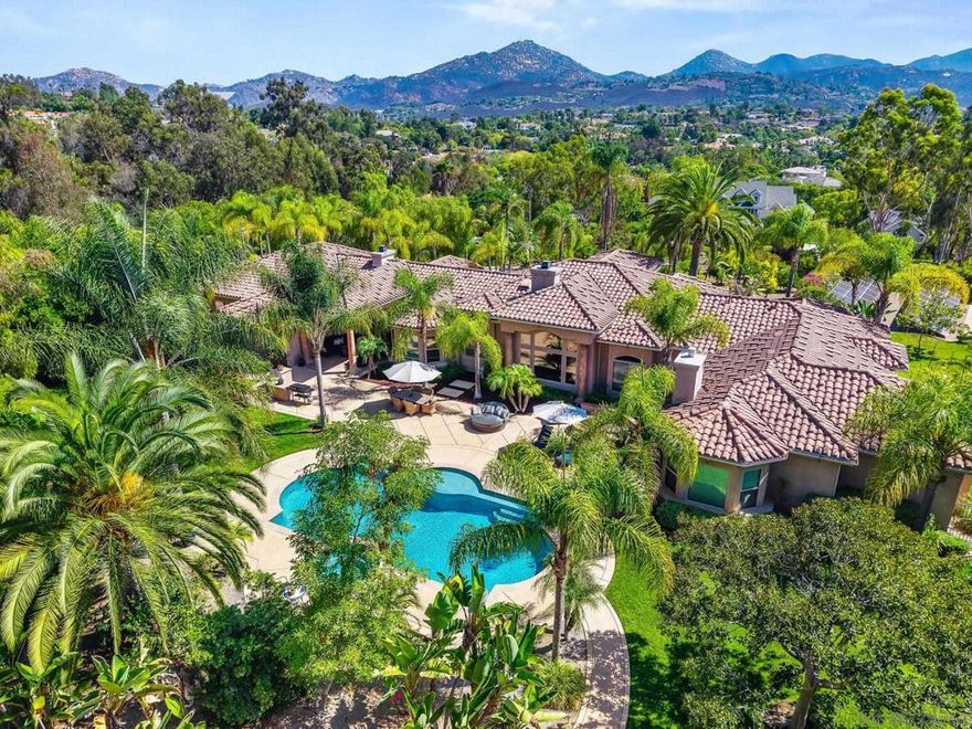 Exquisite Single-Level Estate with a detached Casita in Green Valley Summit  Located in the prestigious enclave of Green Valley Summit positioned close to schools, lake and park. This extremely private oasis exudes a rare blend of privacy, sophistication, and resort-style living nestled in the scenic hills, there are panoramic views from every direction. Set on over two meticulously landscaped acres, this home captures the essence of Southern California luxury. As you arrive, you’re welcomed by breathtaking mountain views and fruit orchards from the front of the property, creating a dramatic and unforgettable first impression. Inside, the home features over five spacious bedrooms, a dedicated media room, and a detached casita—perfect for guests, extended family, or a private office space. Crafted with the highest attention to detail, the interior showcases hardwood cabinetry, slab granite countertops, and elegant travertine flooring, all complemented by commercial-grade stainless steel appliances in a gourmet kitchen designed for both form and function. A newly installed air conditioning system ensures year-round comfort, while a high-end water purifier and softener system provide clean, refined water throughout the home. Step into the resort-like backyard, where you’ll find a heated pool and spa, surrounded by $300,000 in lush, professional landscaping that offers complete privacy and serenity. The backyard provides a tranquil retreat, enhanced with a covered entertaining area and beautiful mature trees.  Further elevating the property is a private well and reservoir tank, supporting eco-conscious irrigation for both the landscaping and the orchard. A  upgraded sprinkler system ensures efficient water distribution across the expansive grounds. The 4-car garage includes a high-end EV charging system, and the home is outfitted with a new alarm system, enhanced whole-home WiFi and Ethernet infrastructure, and an upgraded speaker system for seamless connectivity and entertainment throughout.       This is truly a one-of-a-kind opportunity to own a home that combines timeless design with a luxurious Mediterranean masterpiece in one of Poway’s most exclusive neighborhoods. With top-rated schools, hiking trails, and upscale amenities just minutes away, this estate delivers an unparalleled lifestyle—indoors and out with about 450K of upgrades !