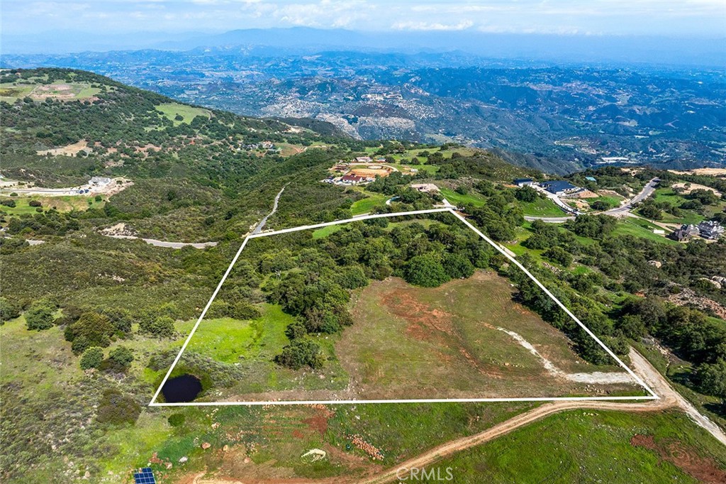 APN_ 932-070-033: Almost TEN ACRES in beautiful Tenaja on the Santa Rosa Plateau, with views of the OCEAN, VALLEY AND MOUNTAINS! This parcel provides a rare opportunity to live in a pristine, natural setting, with paved road, available public water, surrounded by Nature Conservancy, among ancient oak trees (many are rare Englemann Oaks), gorgeous rock outcroppings, and forever views. Public water is is already on property next door, which greatly minimizes your cost to build. Private, quiet, serene, and located on the corner of the paved Corona Cala Camino and El Cerezo, this stunning parcel is ready for your dream estate, which may include main house, ADUs, barn, workshops, a private water well (water currently provided in the area by city water), etc. Imagine sitting on your future patio, gazing at the views and enjoying the deer that frequent the property. You will feels worlds away, yet you are within a 15-minute drive to all the amenities of town. This is an ideal setting for a DREAM ESTATE! Build your dream YOUR way! *****SANTA ROSA PLATEAU: 5-acre minimum parcels (10-acre minimum. in SR West), just minutes to schools, restaurants, hospitals, grocery stores, 15 Fwy & Temecula Wine Country. Enjoy this peaceful ranch community w/no commercial businesses, robust social activities, miles of private community trails & 1000s of acres of Ecological Reserve…All less than 1.5 hours from LA, SD, OC, Palm Springs & Big Bear. Discover the country, yet convenient, lifestyle of La Cresta, Tenaja & the Communities of the Santa Rosa Plateau!