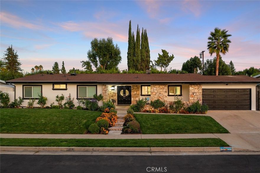 Meticulous and highly upgraded mid-century modern Charles Du Bois single level home! The property sits elevated above the street on a sprawling 11k lot boasting almost 100 feet of frontage adorned with manicured front lawns and lush landscaping. An ascending stone pathway leads to the covered front porch cladded with original stone exterior. Step through double doors into the entry foyer that opens to expansive living & dining rooms each with tongue & groove wood beamed vaulted ceilings, original stone fireplaces, and two sets of glass sliders that open to the backyard for the perfect indoor/outdoor flow. The oversized remodeled kitchen boasts large island with breakfast bar seating, quartz counters with soft close cabinetry, wine fridge, and a suite of Forno stainless appliances including a 60” fridge/freezer and range with double ovens and 8-burner stove with pot filler. The spacious primary suite features high vaulted ceiling, glass slider that opens to the yard, large walk-in closet, separate makeup vanity, and en-suite upgraded bathroom with dual sinks, spa tub, and separate walk-in shower. Two of the secondary bedrooms have high vaulted ceilings and share a spacious remodeled bathroom with new vanity with stone counter, dual sinks, and walk-in shower. There is a separate wing of the home which has both interior and exterior access making it the ideal flex space for extended family, home office/studio space, or great rental income featuring two additional bedrooms, a bathroom with dual sinks and walk-in shower, a separate full kitchen with stainless appliances, and its own private fenced-in yard separated from the main yard with patio, grass lawn, and storage shed. The home also has a spacious laundry room with built-in storage. The entertainer’s backyard has a sweeping covered patio perfect for outdoor dining and lounging, lush grass lawn with mature trees, and large side yard with additional storage shed. Adjacent to dining/shopping at the Westfield Mall/Village, Calabasas Commons, local parks/hiking, & zoned for award-winning El Camino & Hale charter schools.