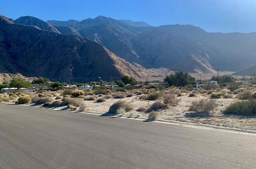 Awesome Mountain Panoramic Views.Less then 10 mins from Downtown Palm Springs, ( carries the 92262 Zip code and Services) also approximately 10 degrees Cooler then PS.  5 mins to I-10 for easy Westward travel.This level flat view lot is ready for development -on a paved street, close to electric & water.San Jacinto Cove was an early  MID- C  Home development area.Variety of housing is permitted.