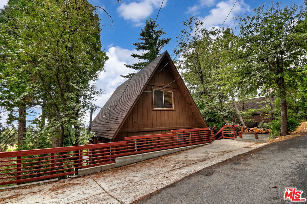 Perched high among the pines, this rustic A-frame cabin offers the perfect blend of mountain charm and modern updates. Featuring 3 bedrooms, 1 bathroom, and an in-home laundry area, this inviting retreat is ideal as a full-time residence, weekend getaway, or investment property.Step inside to discover all-new flooring, fresh interior paint, a beautifully refinished kitchen, updated electrical breaker box, and a new thermostatmaking this property truly turn-key.The heart of the home is the cozy main living area, where a stunning panoramic A-frame window floods the space with natural light and frames breathtaking views of the surrounding forest. It's the perfect spot to unwind and soak in the peaceful treetop setting.Located just a short drive from Highways 18 and 330, this mountain bungalow also offers convenient parking and easy access to local amenities, Lake Arrowhead, and outdoor adventure.Whether you're dreaming of a quiet escape or a place to make lasting memories, this enchanting cabin invites you to experience mountain living at its finest.