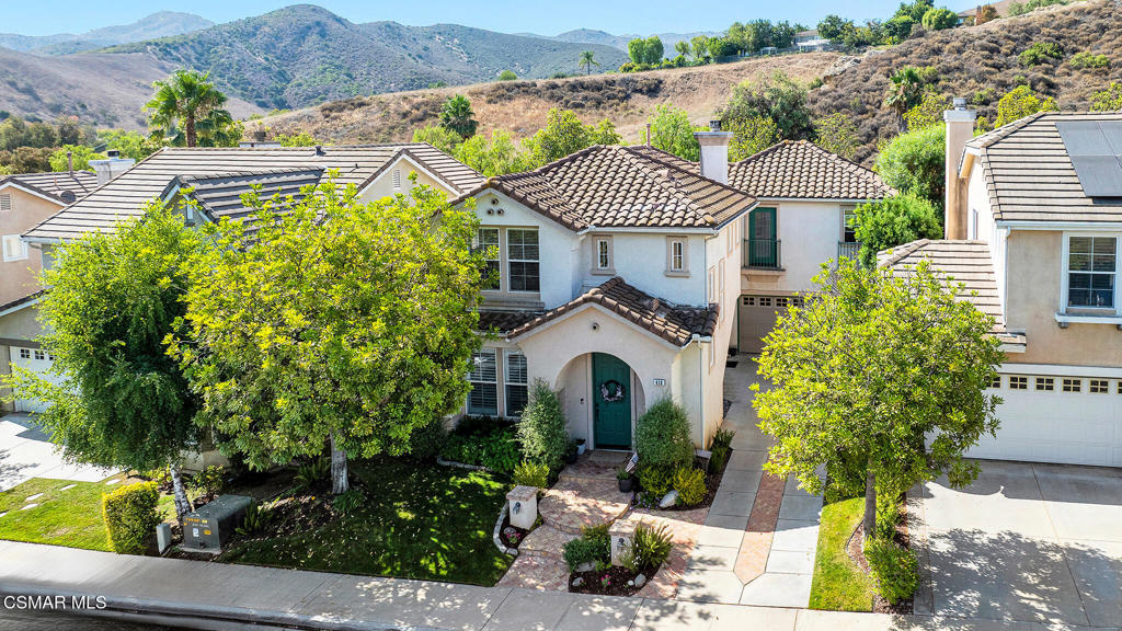 Here's your chance to own a home in the highly sought-after guard-gated Long Canyon Windmill community at Wood Ranch--a neighborhood known for its tree-lined streets, resort-style amenities, and easy access to parks, trails, golf, shopping, and dining. Offering 4 bedrooms, 2.5 baths, and 2,069 sq. ft. of living space on a 3,484 sq. ft. lot, this home combines comfort, style, and convenience in one inviting package. Step inside to a light-filled living room with soaring ceilings and warm wood flooring that set the tone for the open, welcoming layout with a downstairs remodeled powder room. The granite kitchen features dark wood cabinetry, a tumbled travertine backsplash, a center island with storage, stainless steel appliances, and a roomy pantry--perfect for both everyday meals and entertaining. Just off the kitchen is a dining area with three large windows, creating a bright and comfortable space for enjoying meals. The kitchen flows seamlessly into the family room, where a tile fireplace adds a cozy touch, and sliding doors open to a backyard with a concrete patio for outdoor dining and block wall fencing for privacy. Upstairs, wood-like flooring extends through most of the space. The primary suite is a peaceful retreat with hilltop views, a Juliet balcony, a large walk-in closet, and an ensuite bath with a soaking tub, separate shower, and dual-sink vanity. Three additional bedrooms and a full hall bath with dual sinks provide plenty of space for family, guests, or a home office, and the upstairs laundry room adds convenience. The front yard features lush landscaping with terracotta tile accents, and the property includes a direct-access two-car garage. As a Long Canyon resident, you'll enjoy four sparkling pools and spas, three clubhouses, a fitness center, tennis courts, playgrounds, and scenic walking and biking trails--all within a secure, beautifully maintained setting.