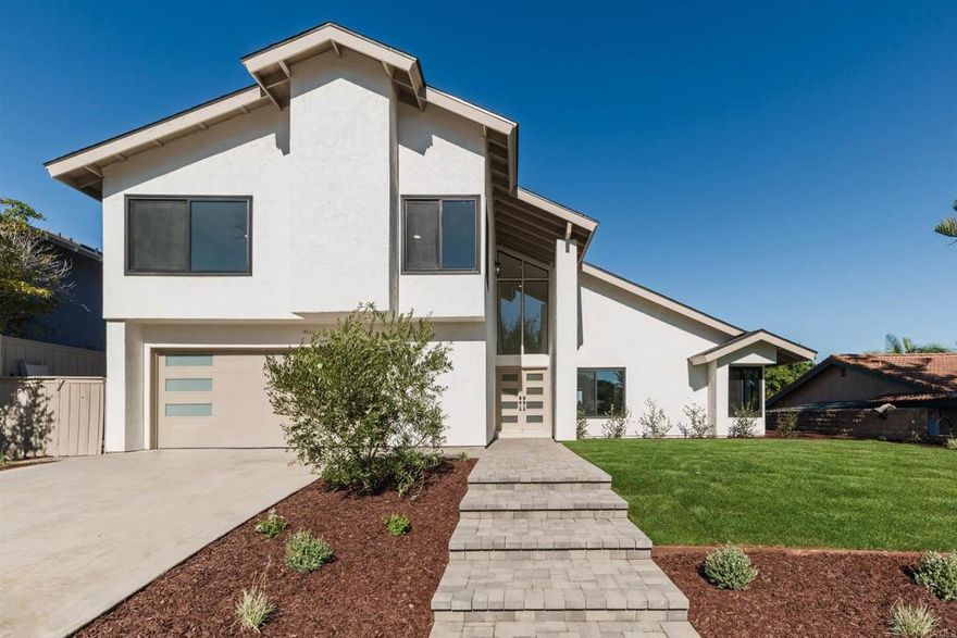 Step into this stunning, fully remodeled 4-bedroom, 3.5-bath home, where every detail has been thoughtfully crafted with high-end finishes and timeless modern style. From the brand-new interior to the lush new landscaping, this home offers the perfect blend of luxury, comfort, and sophistication.  Inside, you’ll find custom cabinetry throughout the main living areas, engineered hardwood flooring, and quartzite countertops that add both beauty and durability. The kitchen is a true showpiece—featuring luxury appliances, a farmhouse sink, and an 8-burner Forno range with duel ovens that will delight any home chef. Designer touches elevate every corner, from the parquet onlay on the back of the kitchen island to the fluted accent wall in the primary bedroom. There’s abundant storage and beautifully crafted built-ins throughout. A convenient pass-through window connects the kitchen to the backyard deck, perfect for entertaining and al fresco dining.  The extra-wide staircase leads to a spacious primary suite, complete with a large walk-in closet with custom built-ins and a private view deck overlooking the rolling hills and canyon views—the ideal spot to enjoy peaceful mornings or sunset evenings. The luxurious ensuite bath offers a spa-like retreat, showcasing an oversized wet-room style shower with a soaking tub inset, and exquisite modern brushed bronze fixtures and finishes.  One of the additional bedrooms also features its own private ensuite bathroom, offering wonderful privacy for guests or multigenerational living. Every bathroom includes custom vanities, designer tile work, and brushed bronze faucets that tie the home’s modern aesthetic together.  The den provides a warm, inviting space with a cozy fireplace and wet bar, perfect for relaxing or entertaining. A set of three-panel shaker doors opens from the living room to the backyard, creating a seamless indoor-outdoor flow. The front and backyards have been refreshed with all-new landscaping, new lawns, and a brand-new deck for easy outdoor living.  The epoxy-coated garage floor adds both style and function, complementing the home’s long list of upgrades including a new roof, new windows, new HVAC system, and meticulous attention to craftsmanship in every finish.  Located in one of Carlsbad’s most desirable neighborhoods, this home is close to top-rated schools, scenic parks, shopping, dining, and miles of nearby trails—just minutes from the coast. 2568 Abedul St is the definition of move-in ready—brand-new, beautifully designed, and ready to welcome you home.