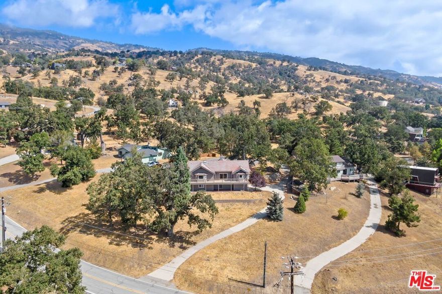 Incredible deal - Priced $130K below the most recent appraisal of $751,500 for a quick sale! Welcome to your forever dream home at 24500 Deertrail Drive in Bear Valley Springs, Tehachapi, CA. This stunning two-story residence offers 3,825 sq ft of open living space with 4 bedrooms and 4 bathrooms, set on a 1.2-acre oak-studded lot with million-dollar panoramic views. Recent upgrades include a new AC and heating system, water heater, fresh interior paint, and new carpeting throughout. Enter into a grand great room featuring vaulted ceilings, rustic wood accents, and a custom fireplace. The updated kitchen boasts dual-color cabinets, a farmhouse sink, industrial-grade stainless steel appliances, and an island barall overlooking breathtaking vistas. Adjacent is the dining area, perfect for entertaining. The main floor includes two primary suites with new carpeting, private balconies, and luxurious en-suites featuring floor-to-ceiling tiled showers, dual vanities, and walk-in closets. Downstairs, discover a massive game room/man cave with its own fireplace, wet bar, epoxy flooring, and separate entrance. Outdoor living is enhanced with multiple decks, including a balcony that spans the length of the property. A long-paved driveway leads to a circular guest parking area, and there's also an attached two-car garage for convenience. Bear Valley Springs offers amenities like golf courses, tennis courts, swimming pools, dining venues, extensive hiking and equestrian trails, and two beautiful lakes. With minimal light pollution, it's perfect for stargazing. Don't miss this rare opportunity to own a slice of paradise where luxury meets nature. Schedule your private tour today!